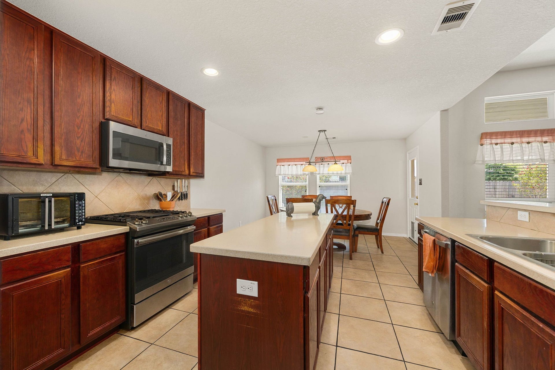 Functional kitchen layout that flows into a bright breakfast nook.