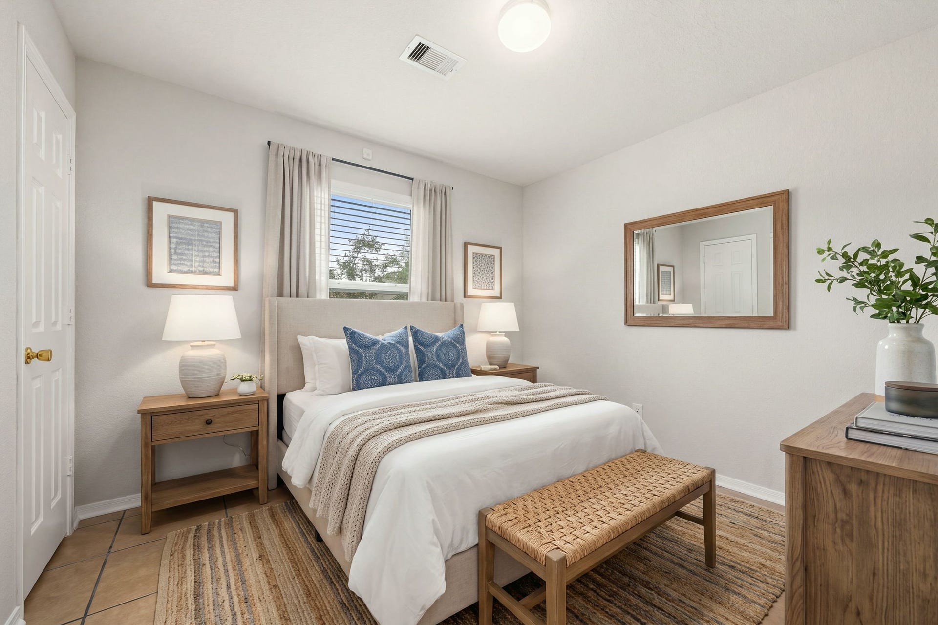 This secondary bedroom features a well-positioned window that provides pleasant natural light. The room features tile flooring and neutral tone walls. it is an ideal setup for family, guests, or a dedicated home office space. *Virtually Staged