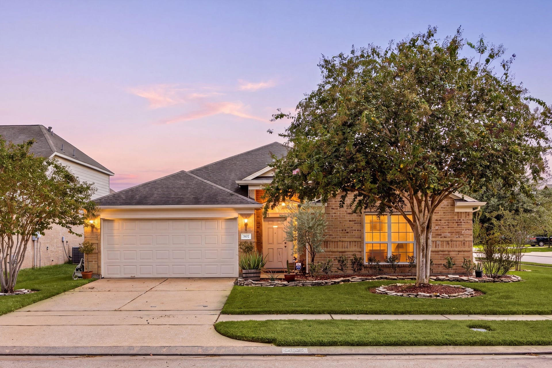 Welcome to 3102 Single Ridge Way, nestled on a large corner lot in the Morton Creek Ranch subdivision in Katy Texas. This charming home showcases beautiful curb appeal with a manicured lawn, mature landscaping, and a timeless brick elevation. An inviting covered front porch, warm wood front door, and classic outdoor lanterns create a welcoming first impression, complete with a spacious double-wide driveway.