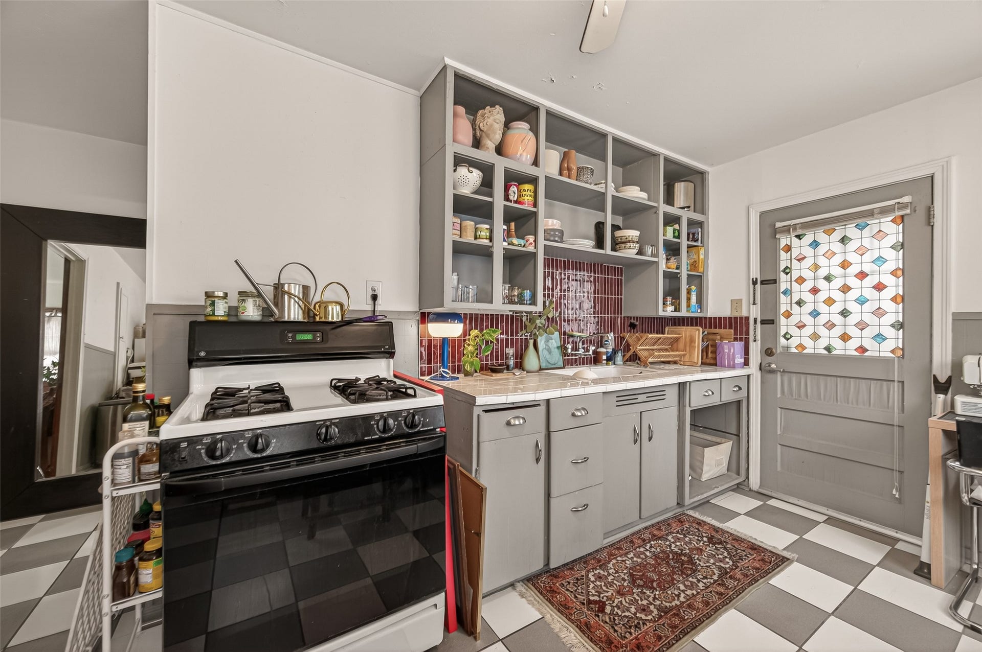 518 N Eastwood Street, Houston, TX 77011 The kitchen features lower cabinetry, and open shelving.