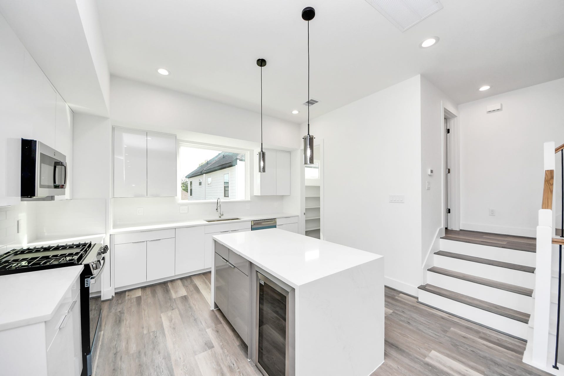 2521 Francis Street, Houston, TX 77004 Kitchen with island and beverage cooler (Sample photo from same floor plan next to the address)