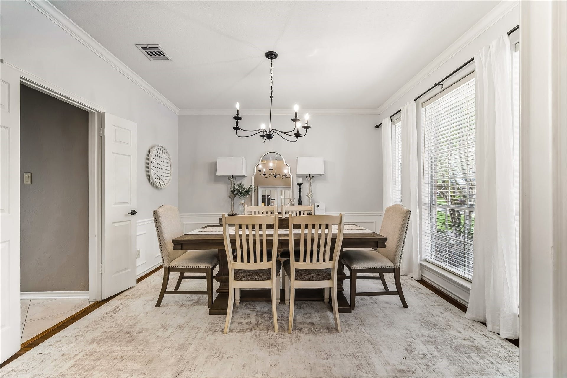 SPACIOUS LIVING ROOM ACCENTED BY WROUGHT-IRON CANDELABRA CHANDELIER - PERFECT FOR HOSTING FAMILY DINNERS!