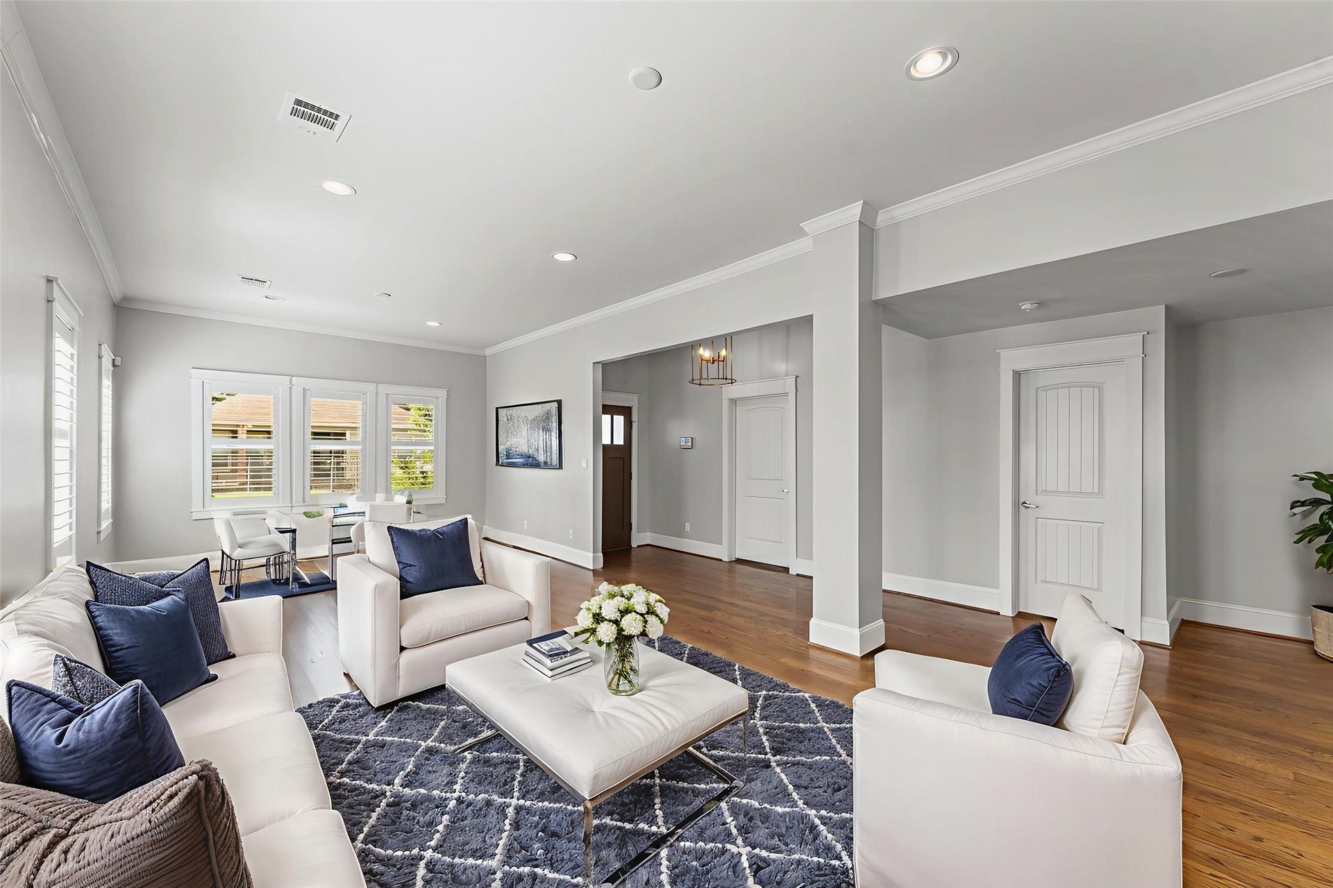 1204 Shearn Street, Houston, TX 77007 This inviting living room features an open layout with abundant natural light. Hardwood floors and light gray walls provide a modern touch, while large windows offer a view outside.