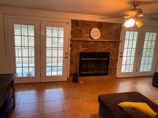 1909 11th Avenue, La Marque, TX 77568 A view of the large family room with doors that open to the large covered patio and a wood burning fireplace.