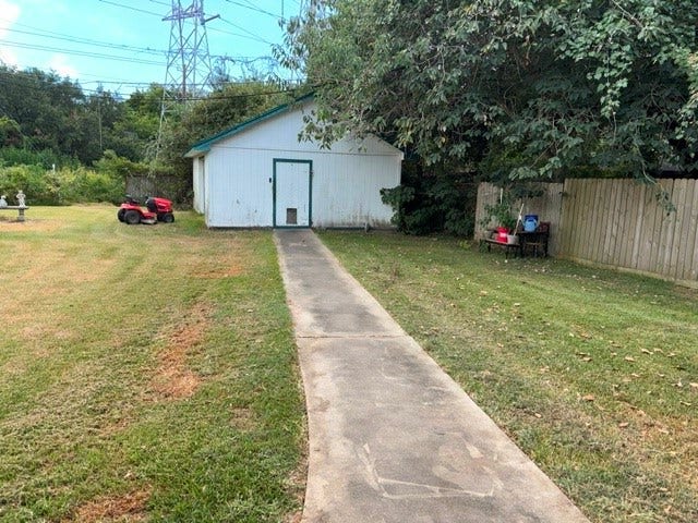1909 11th Avenue, La Marque, TX 77568 A view of the large workshop in the back yard, In addition to the workshop area there are also 2 small rooms with window a/c units that could be craft rooms or some other use.