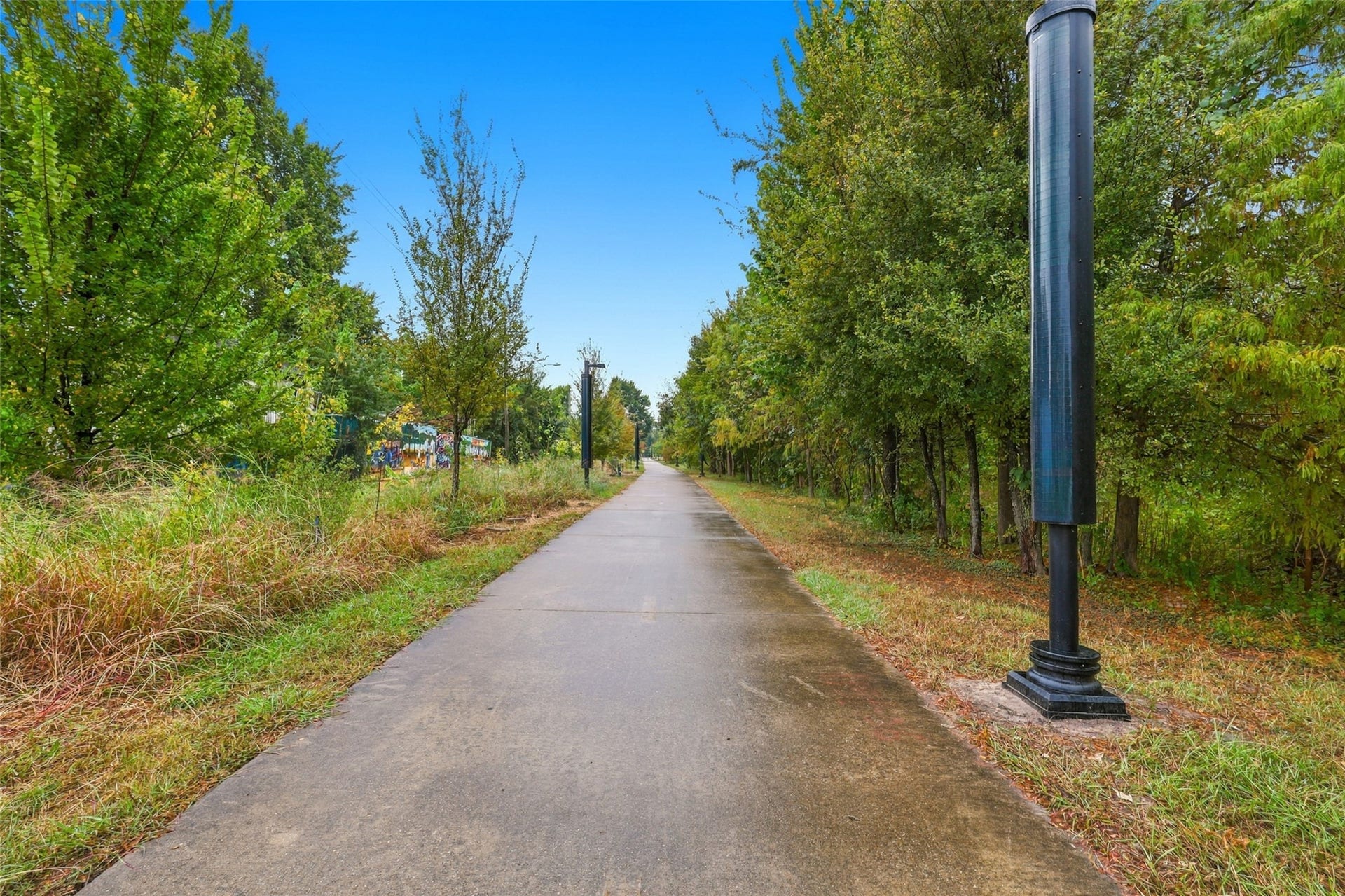 3201 Berry Street, #A/B, Houston, TX 77004 Beautifully landscaped walking trail- The Columbia Tap trail- lined with mature trees and modern streetlights, perfect for leisurely strolls and enjoying nature.