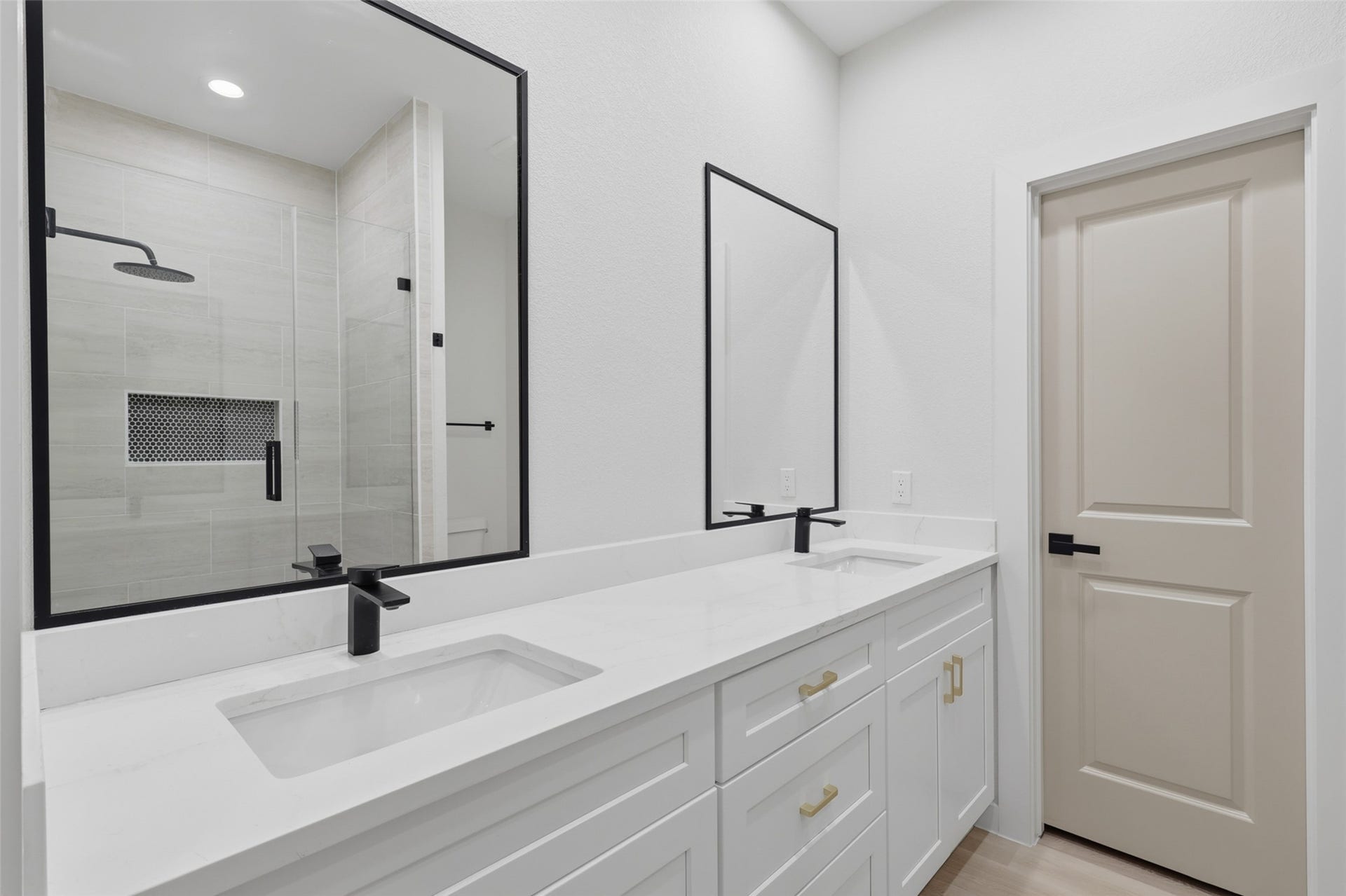 3201 Berry Street, #A/B, Houston, TX 77004 Elegant primary bathroom featuring a double vanity with sleek black fixtures and a spacious walk-in shower with modern tile design.