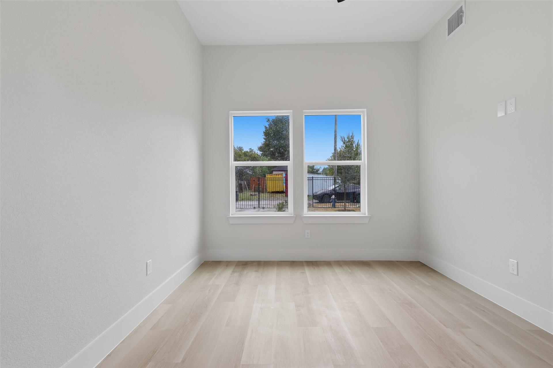 3201 Berry Street, #A/B, Houston, TX 77004 Bright and inviting bedroom room with large windows, sleek light LVP flooring, and neutral walls, offering a versatile space filled with natural light.
