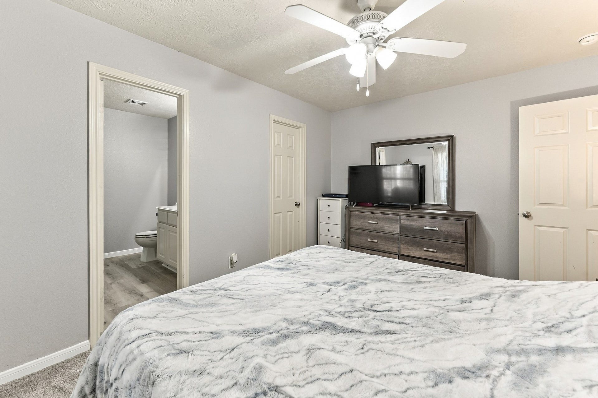 28814 Red River Loop, Spring, TX 77386 Another view highlights the double-door closet & convenient access to the adjoining bathroom. All bedrooms throughout the home feature brand-new carpeting, adding to the recent interior updates.