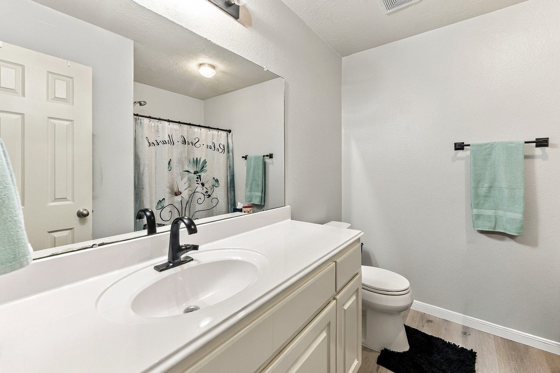 28814 Red River Loop, Spring, TX 77386 The secondary bathroom is clean & well-maintained, featuring a spacious vanity with white cabinetry, ample countertop space, a large mirror & a tub/shower combination. Neutral finishes & built-in storage complete the space.
