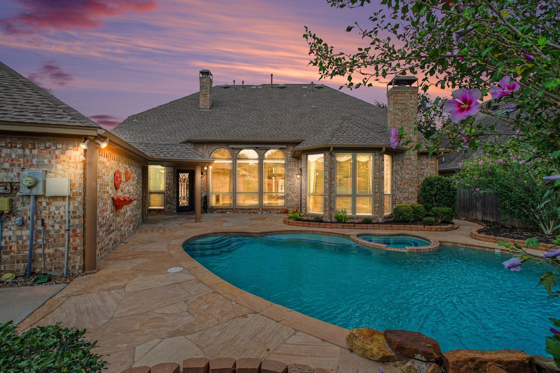 5406 Brook Bend Drive, Sugar Land, TX 77479 Backyard oasis with lush landscaping, heated pool, waterfall feature and hot tub