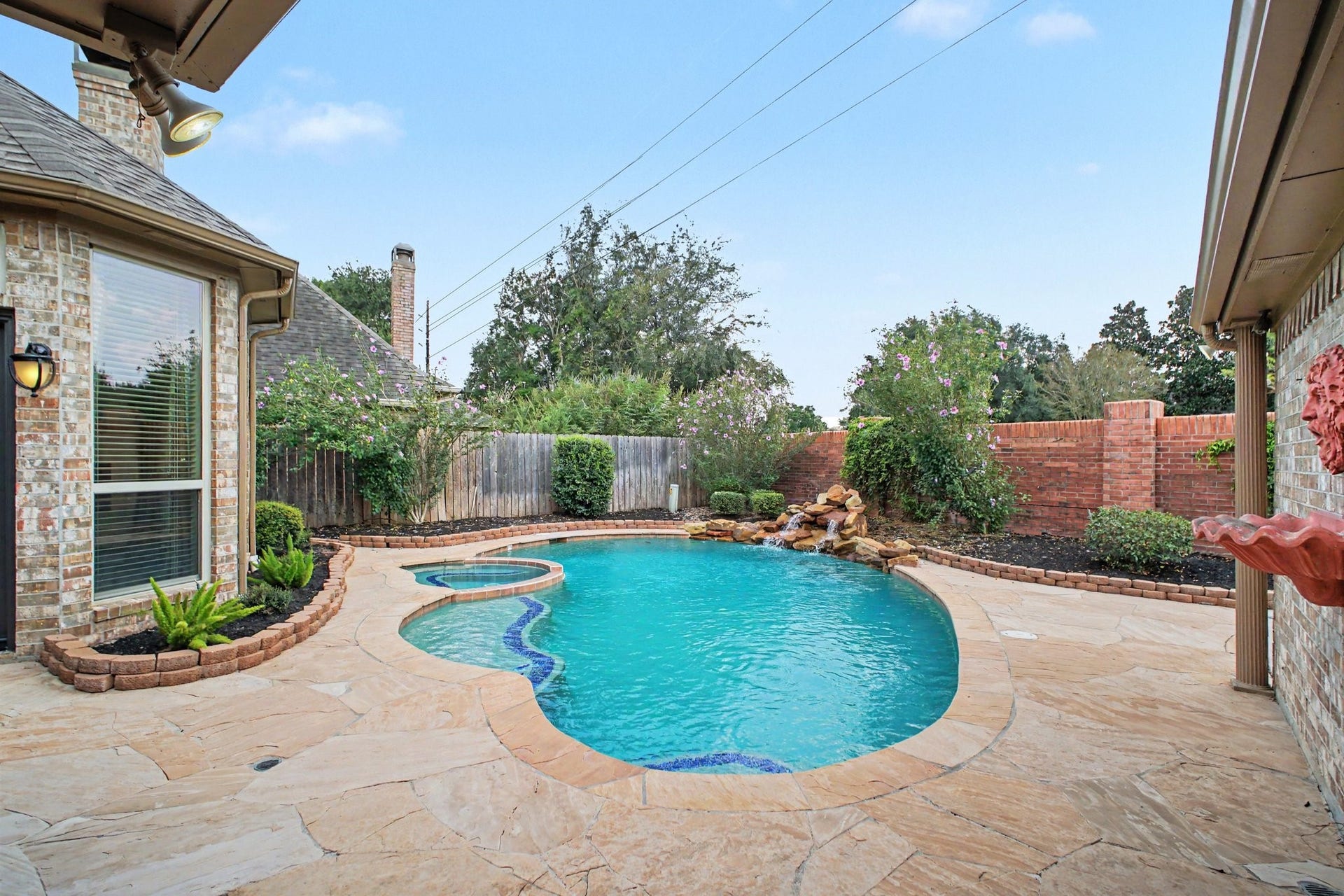 5406 Brook Bend Drive, Sugar Land, TX 77479 The inviting pool has a beautiful water feature which adds a touch of tranquility