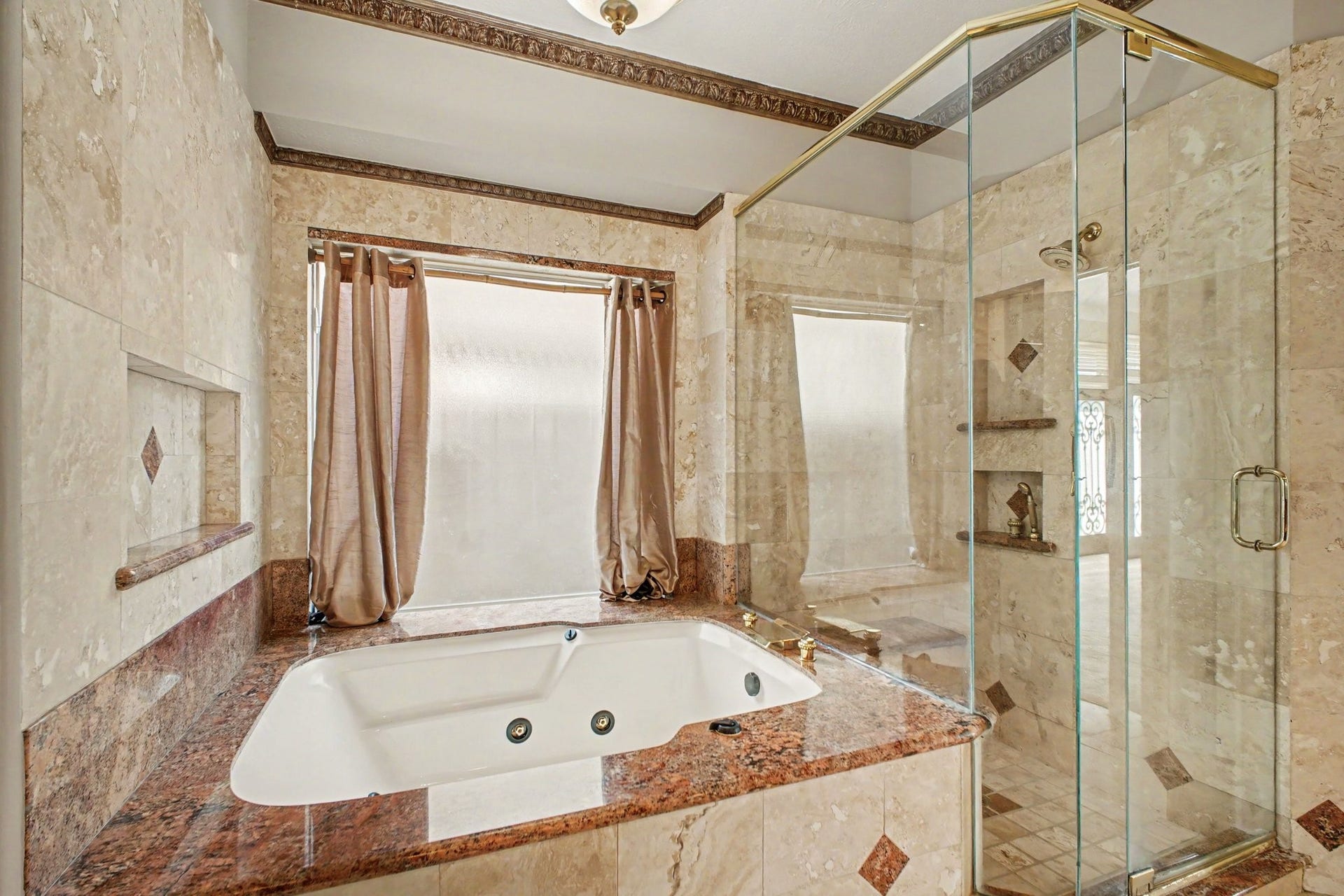 5406 Brook Bend Drive, Sugar Land, TX 77479 The spa-like bath features a seamless glass shower with convenient built-in storage niches and a relaxing jetted tub