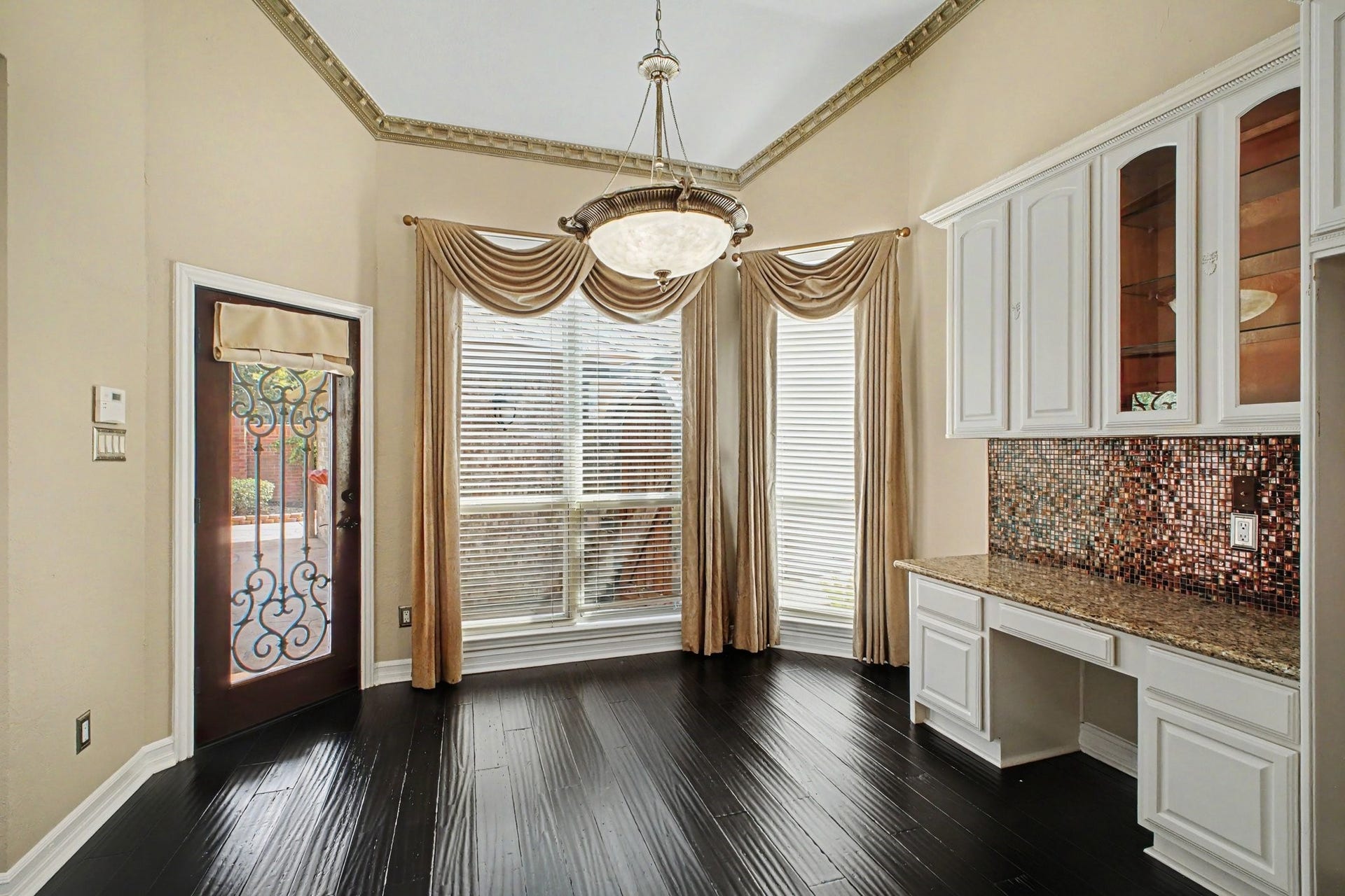 5406 Brook Bend Drive, Sugar Land, TX 77479 A beautiful decorative door opens to the back patio and pool, creating an inviting connection betwee the indoor and outdoor living spaces.
