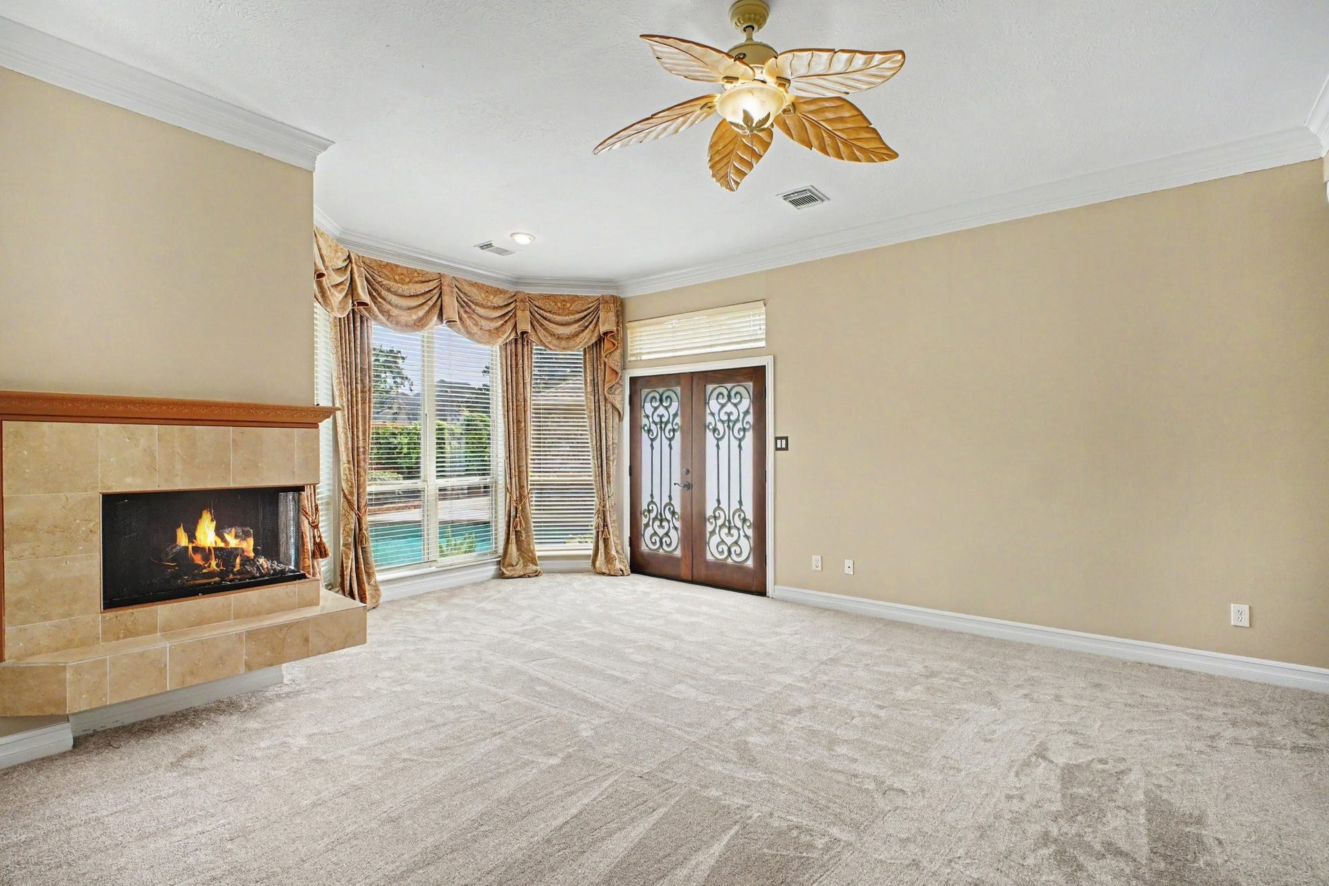 5406 Brook Bend Drive, Sugar Land, TX 77479 A cozy fireplace adds warmth and character to the primary bedroom while a private door leads to the back patio-perfect for stepping outside to enjoy your morning coffee