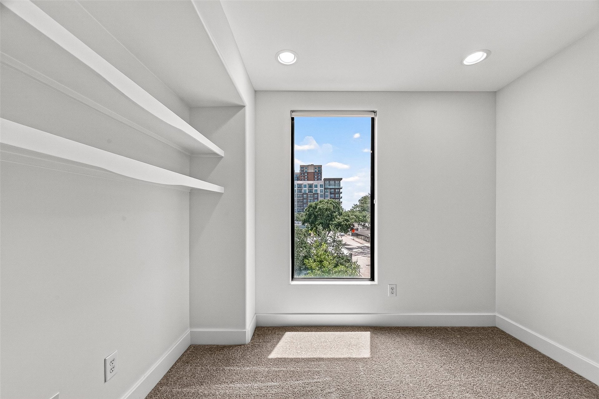 1110 Autrey Street, #C, Houston, TX 77006 Bright and cozy flex space on third floor featuring built-in shelving and large windows, perfect for a home office or reading nook.