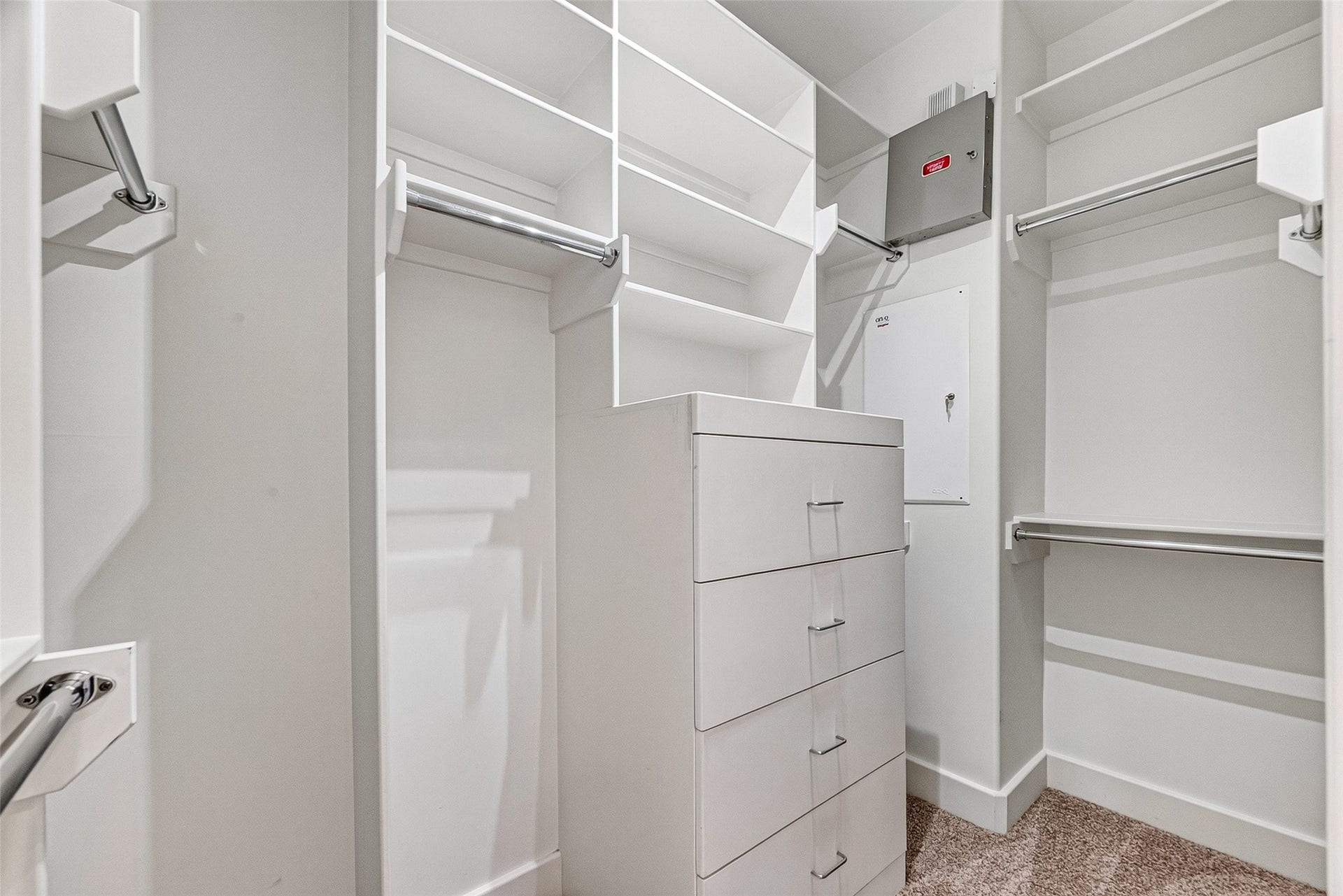 1110 Autrey Street, #C, Houston, TX 77006 One of two spacious primary walk-in closet featuring ample shelving, hanging rods, and a built-in drawer unit for organized storage.