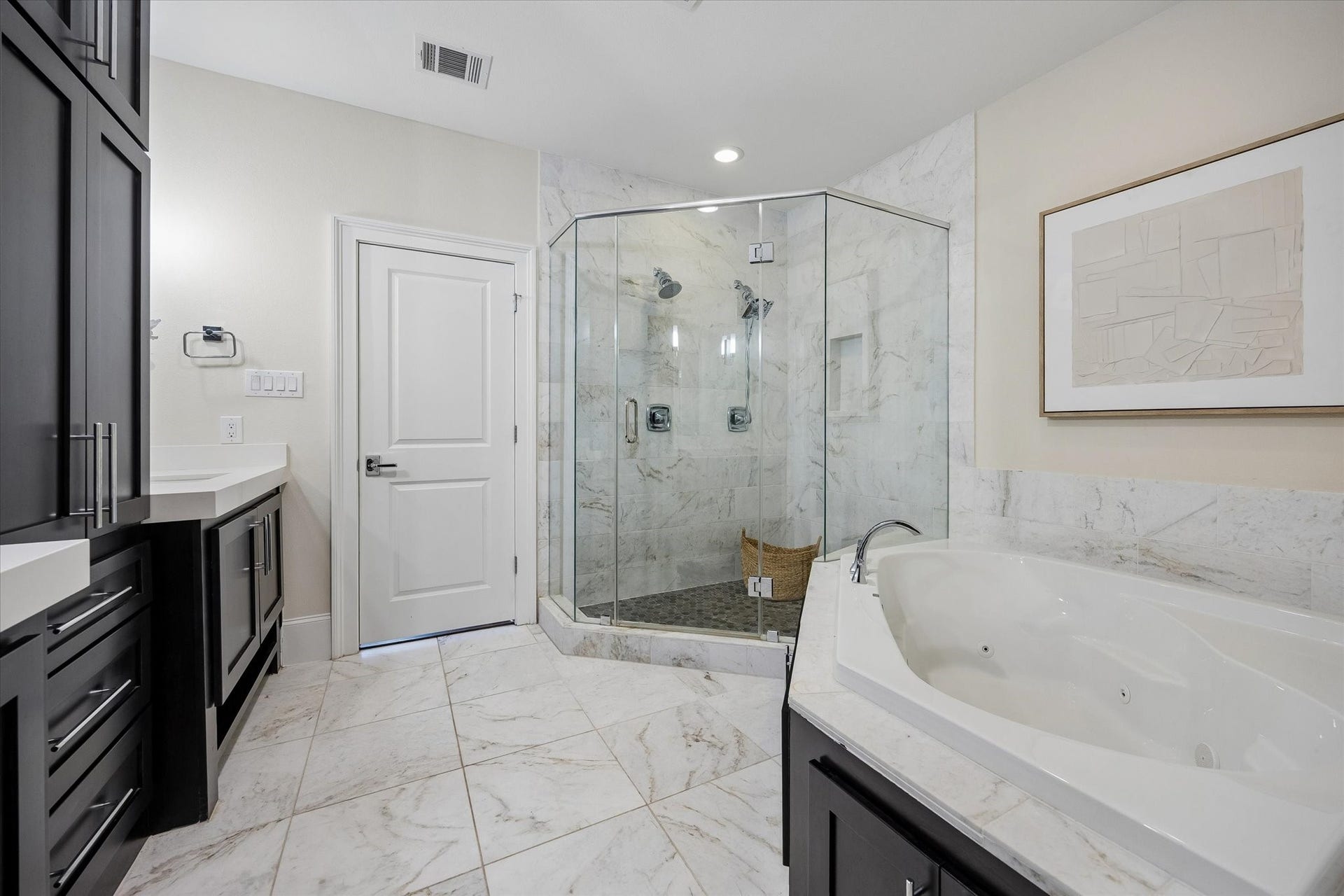 2111 Huldy Street, Houston, TX 77019 The ensuite bath pampers you with a glass enclosed shower with dual shower heads and a large, jetted tub.