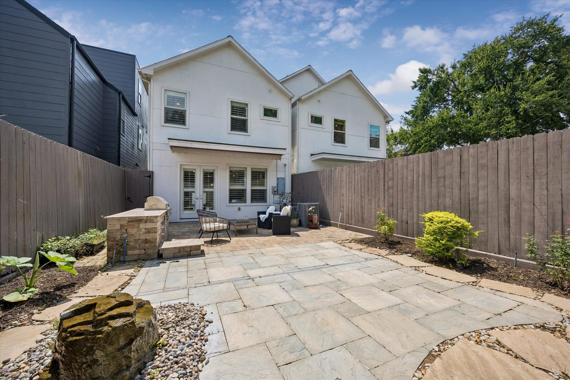 2111 Huldy Street, Houston, TX 77019 Featuring a water feature, the low-maintenance backyard offers a tranquil retreat for relaxing or entertaining friends and loved ones.