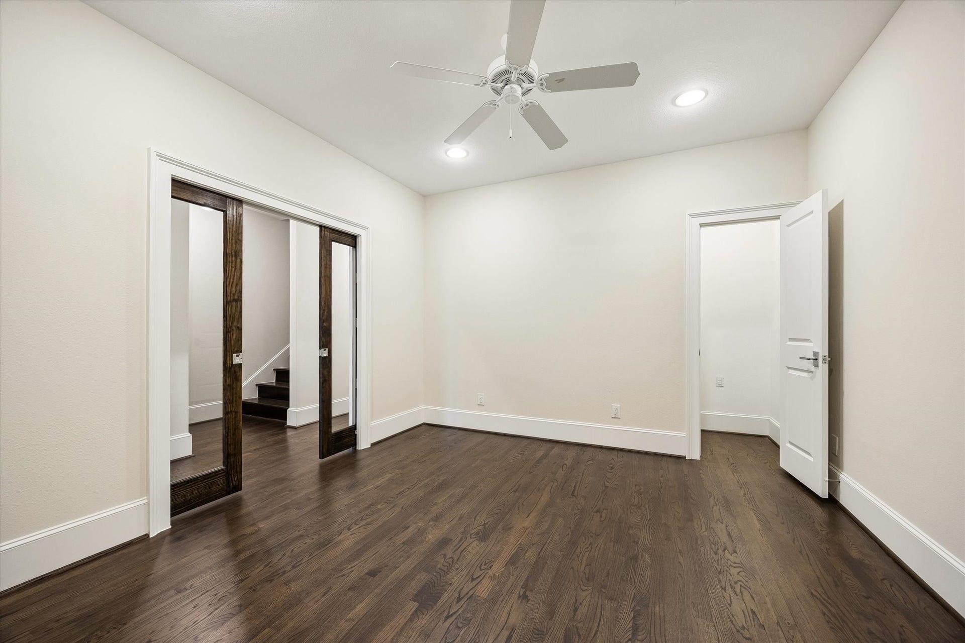 2111 Huldy Street, Houston, TX 77019 Spacious home office with pocket doors, hardwood floors, a closet, and access to a full bathroom.
