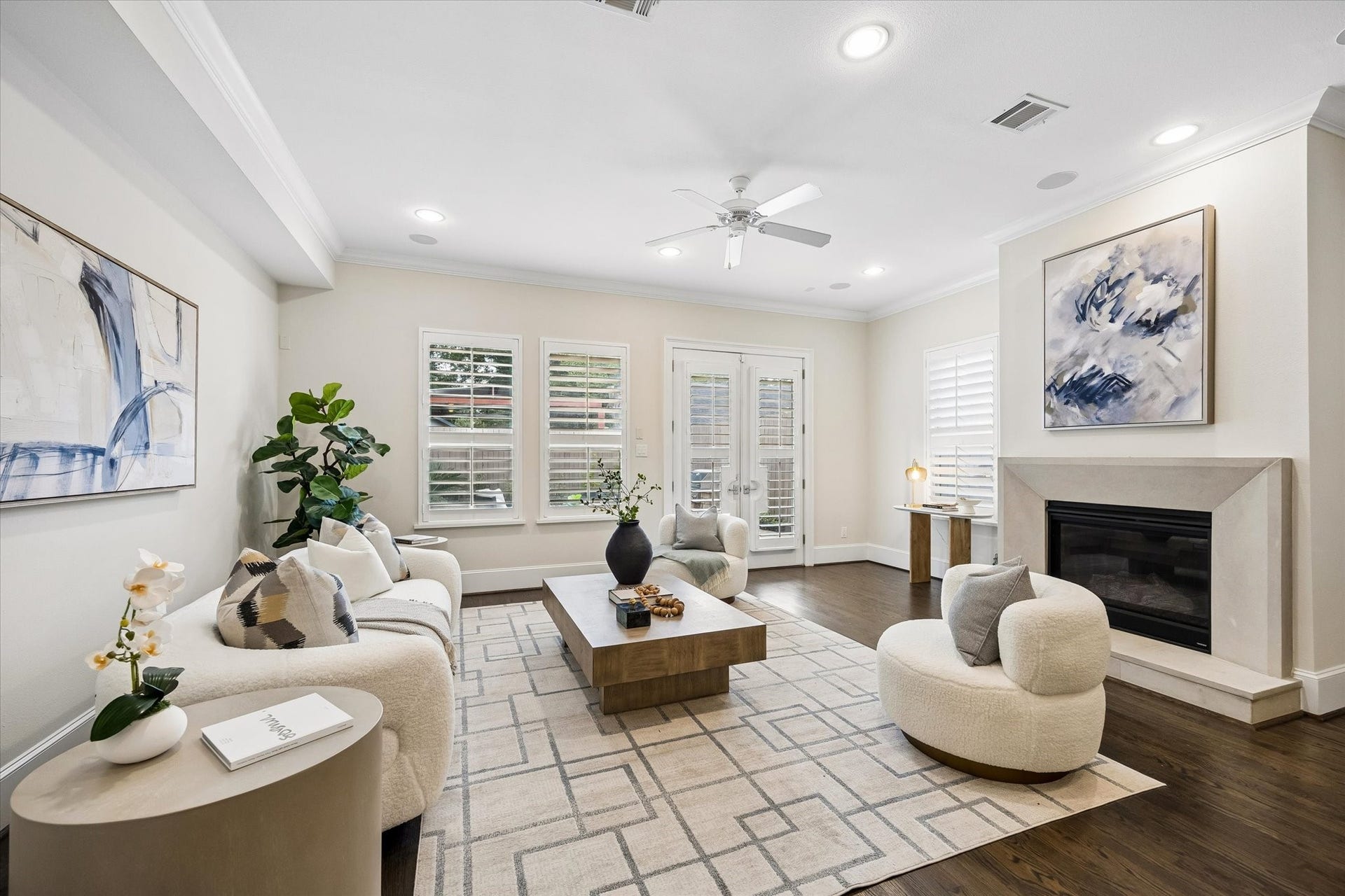 2111 Huldy Street, Houston, TX 77019 Anchored by a cast stone fireplace, the spacious living room features hardwood floors, built-in speakers, recessed lighting, a ceiling fan, and windows that overlook the backyard.