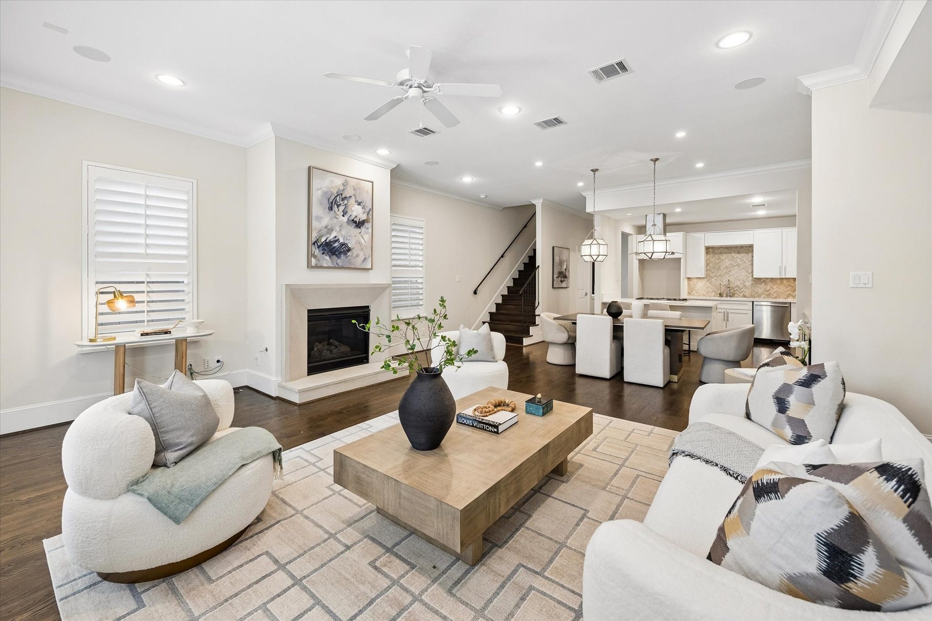 2111 Huldy Street, Houston, TX 77019 The open layout shines with rich hardwood floors and a living room centered by a cast stone fireplace.