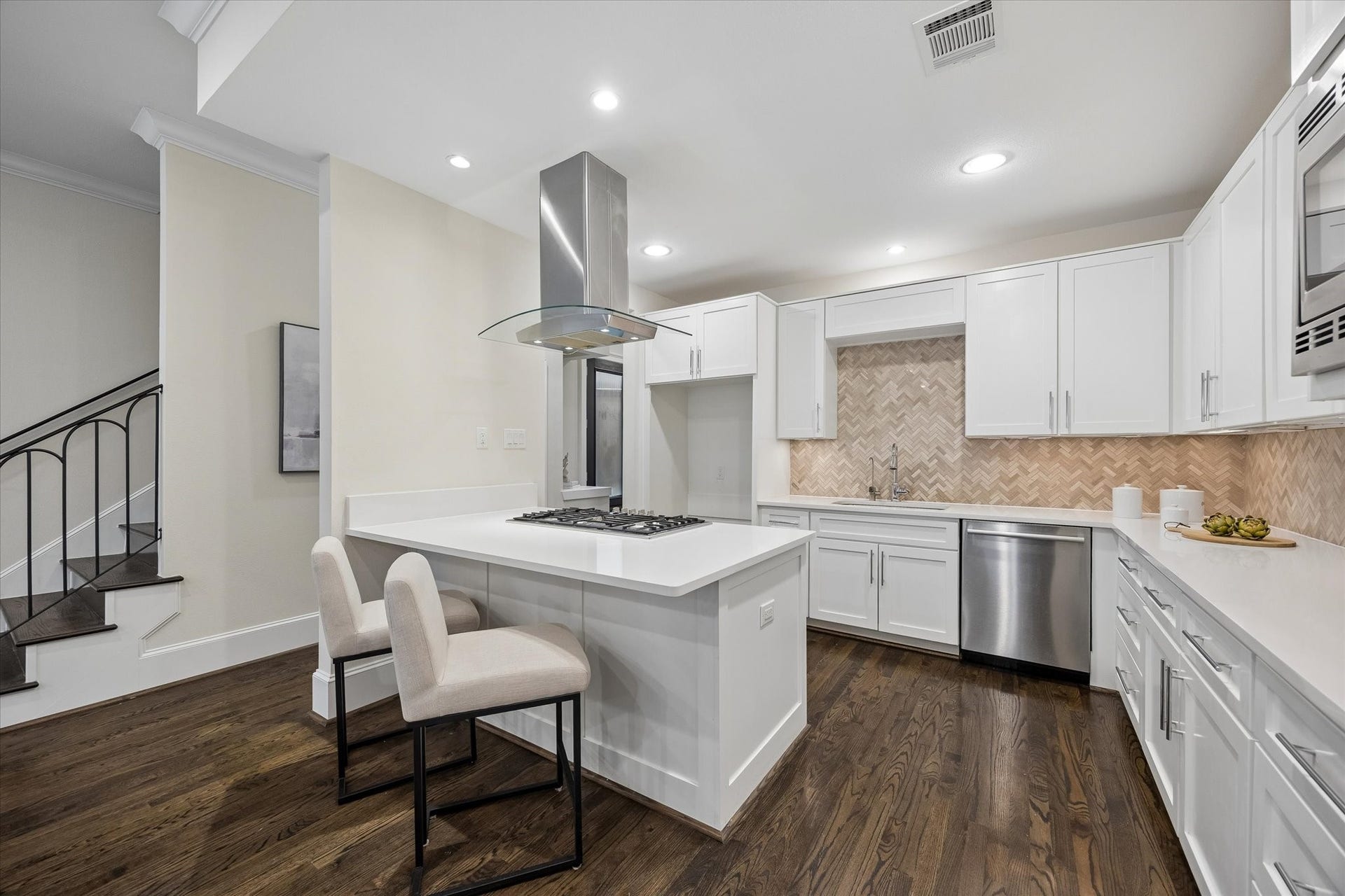 2111 Huldy Street, Houston, TX 77019 A chefs kitchen featuring Bosch appliances, Silestone counters, and an island with breakfast bar.