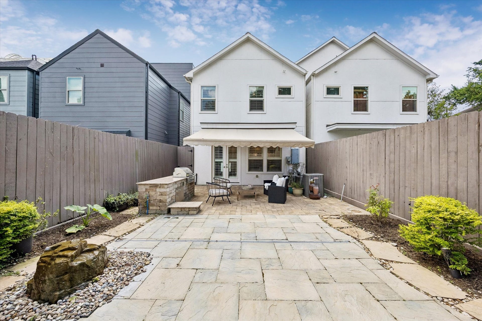 2111 Huldy Street, Houston, TX 77019 Outside, your low-maintenance oasis awaits, featuring a retractable awning, soothing water feature and a built-in outdoor grill with granite counters and storage.