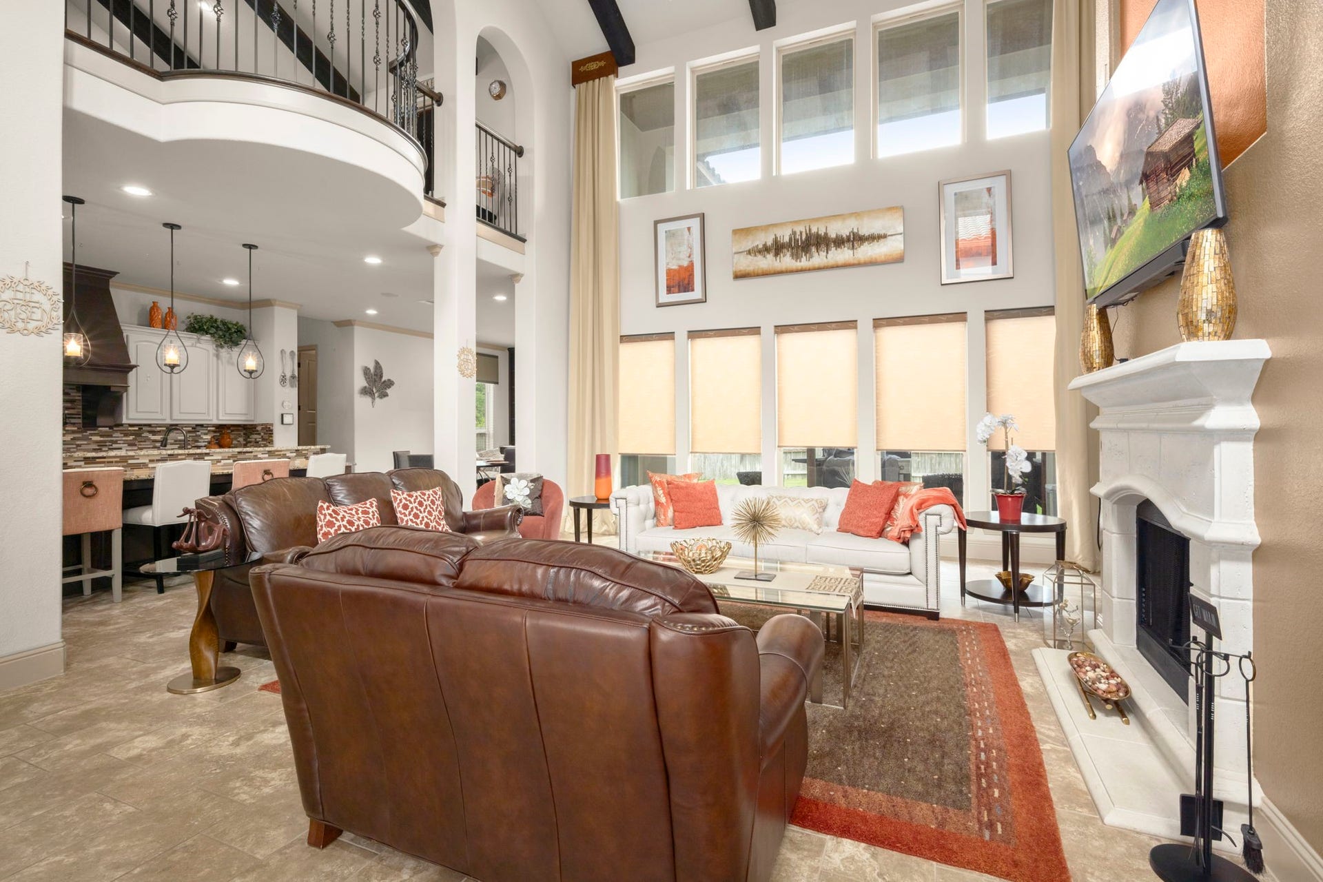 5103 Jackson Ponds Court, Sugar Land, TX 77479 This spacious living room features high ceilings, large windows with abundant natural light, and a central fireplace. The open layout connects to the kitchen area, enhancing the sense of space.