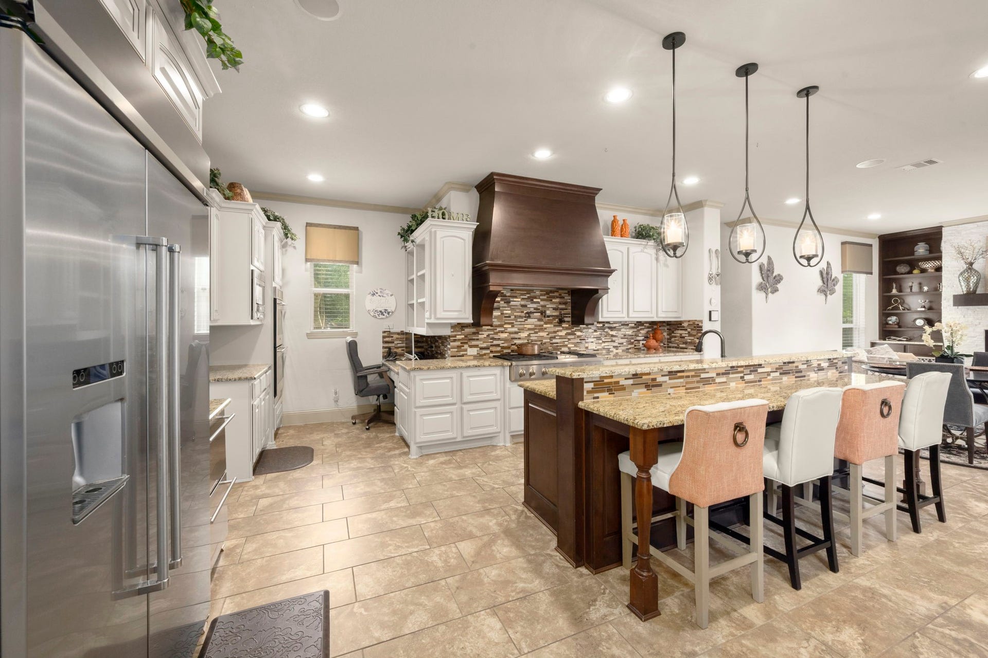 5103 Jackson Ponds Court, Sugar Land, TX 77479 This modern kitchen includes stainless steel appliances, a large island with stylish pendant lighting, a spacious breakfast bar, a walk-in pantry and a secondary kitchenette.