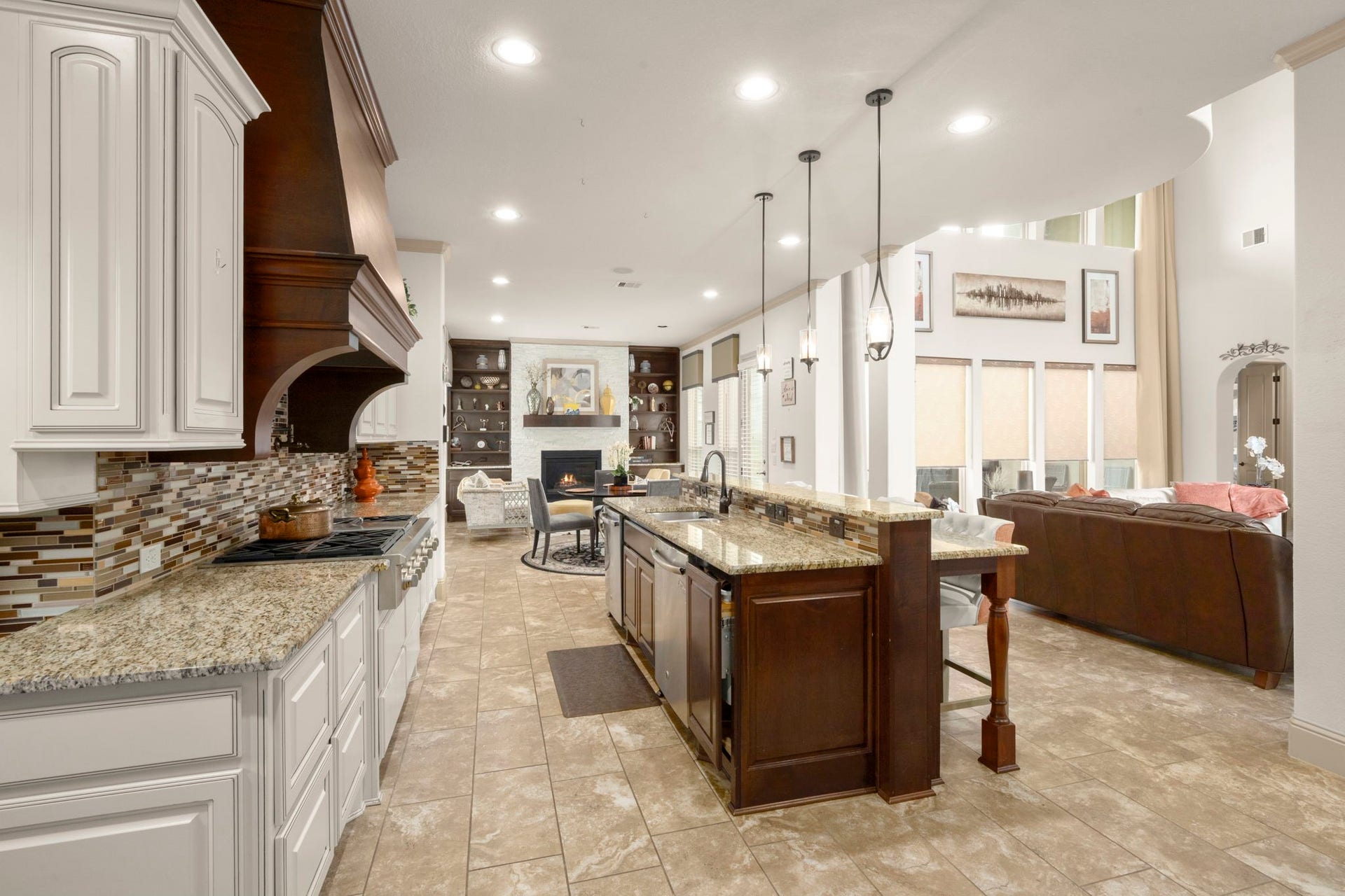 5103 Jackson Ponds Court, Sugar Land, TX 77479 This modern kitchen includes stainless steel appliances, a large island with stylish pendant lighting, a spacious breakfast bar, a walk-in pantry and a secondary kitchenette.