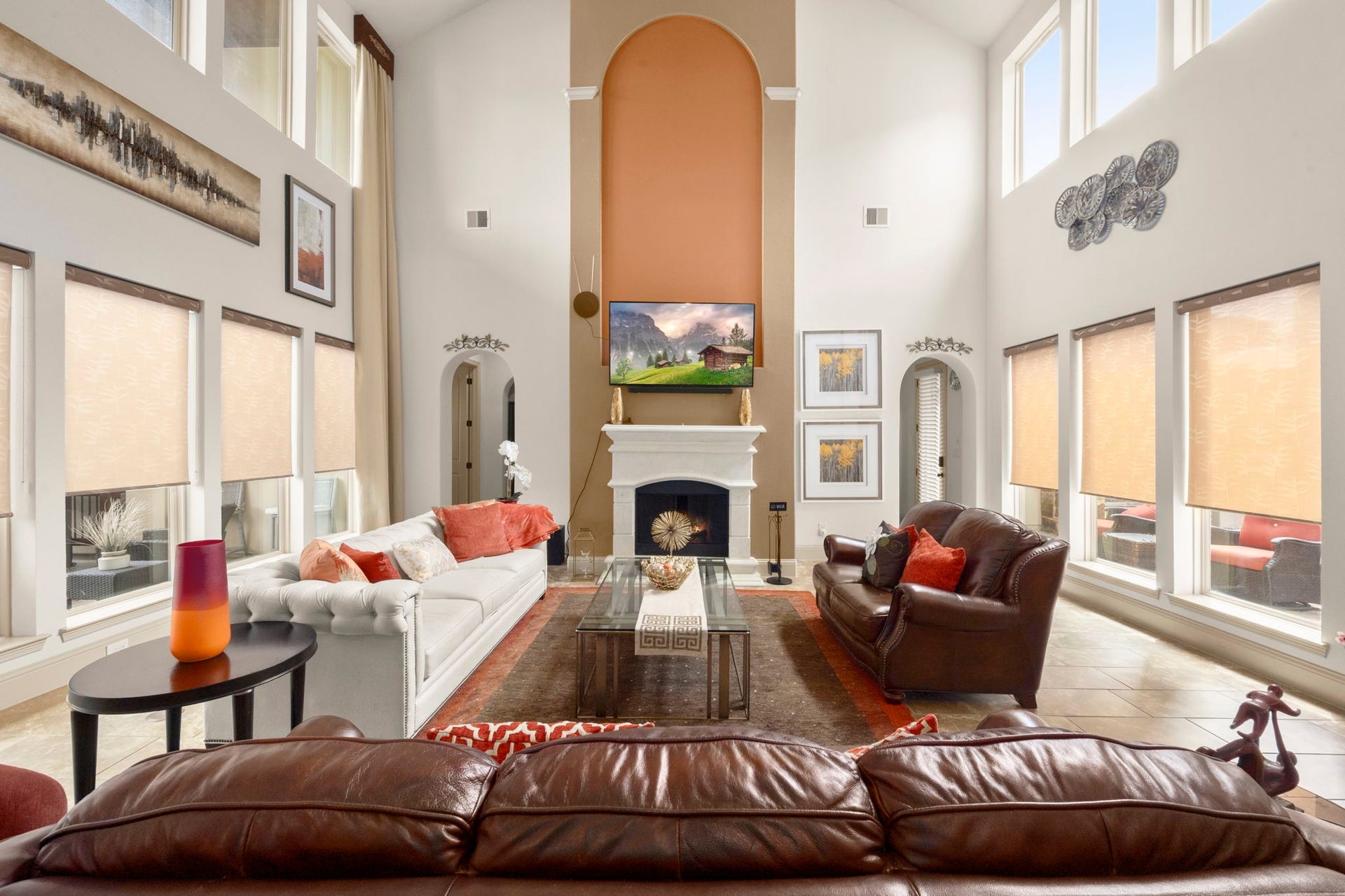 5103 Jackson Ponds Court, Sugar Land, TX 77479 This spacious living room features high ceilings, large windows with abundant natural light, and a central fireplace. This space creates an inviting atmosphere perfect for relaxation and entertainment.