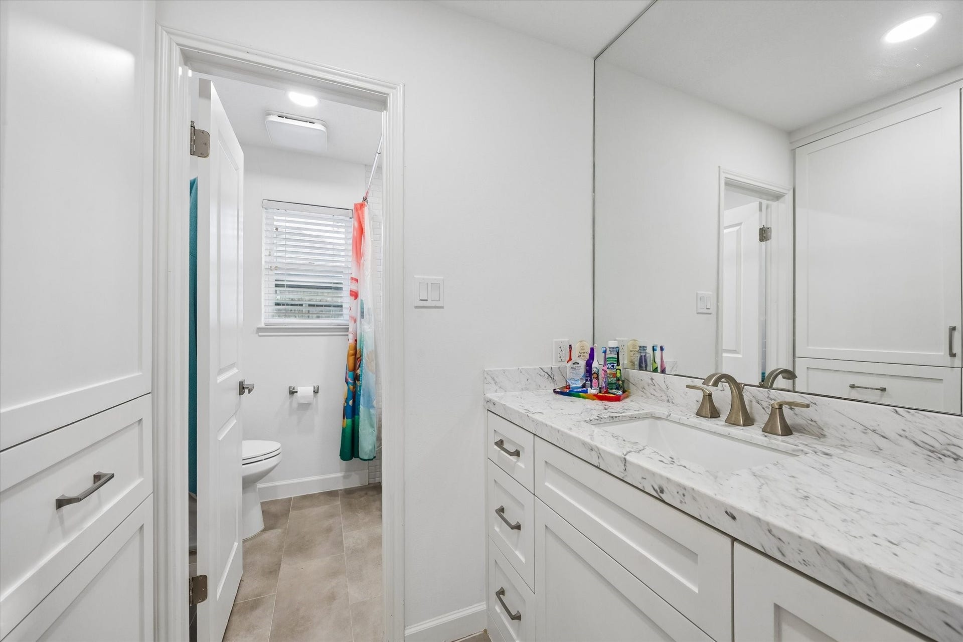 5914 Y Street, Katy, TX 77493 Beautifully renovated secondary bath boasts quartz counters with undermount sink, upgraded cabinet doors, tile flooring & upgraded fixtures/hardware!