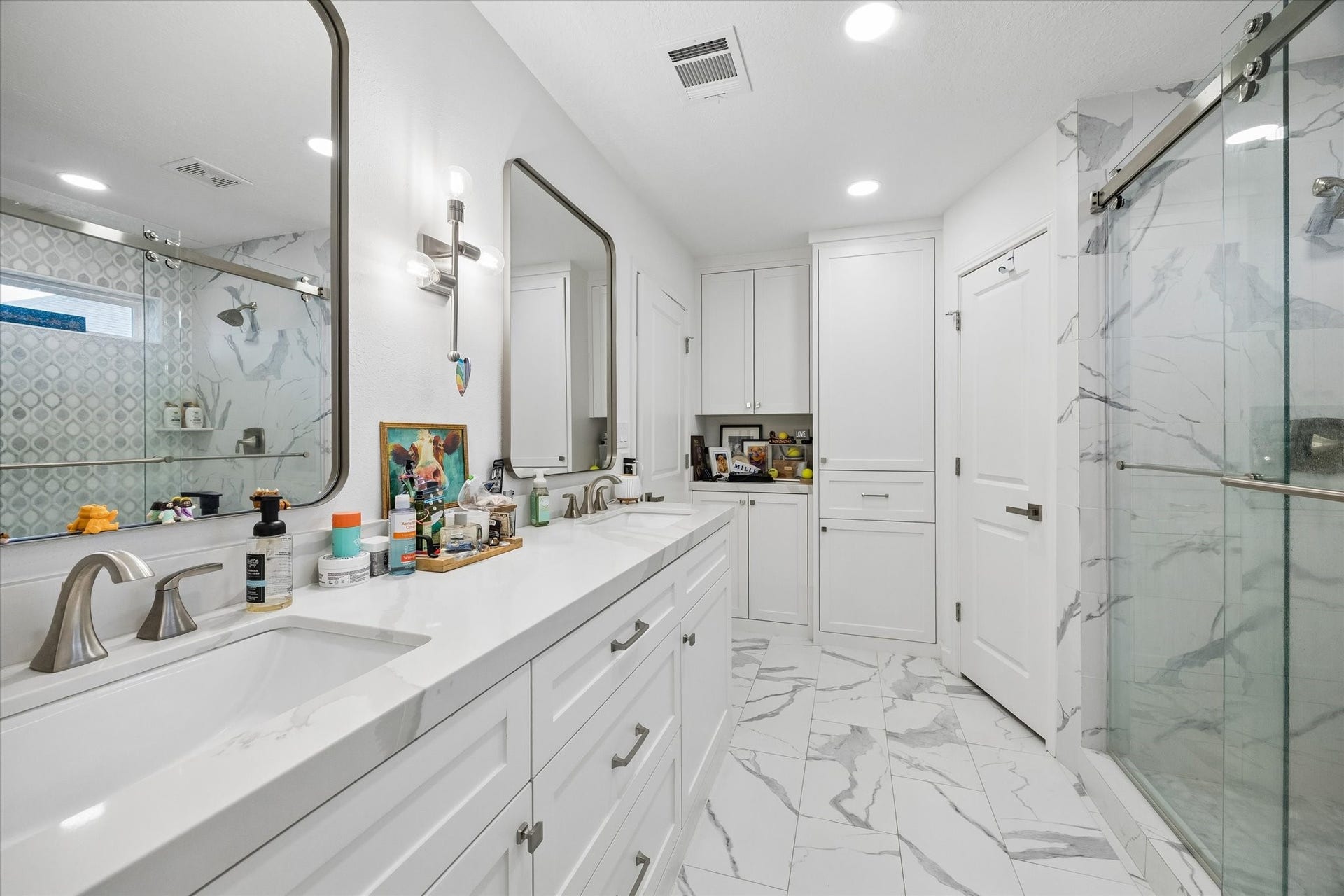 5914 Y Street, Katy, TX 77493 Exquisite & complete high-end renovation creates a spa-like experience with the primary bath. Quartz counters, dual undermount sinks, huge walk-in shower with glass surround, framed mirrors, oversize tile flooring & upgraded fixtures/hardware complete this beautiful renovation!
