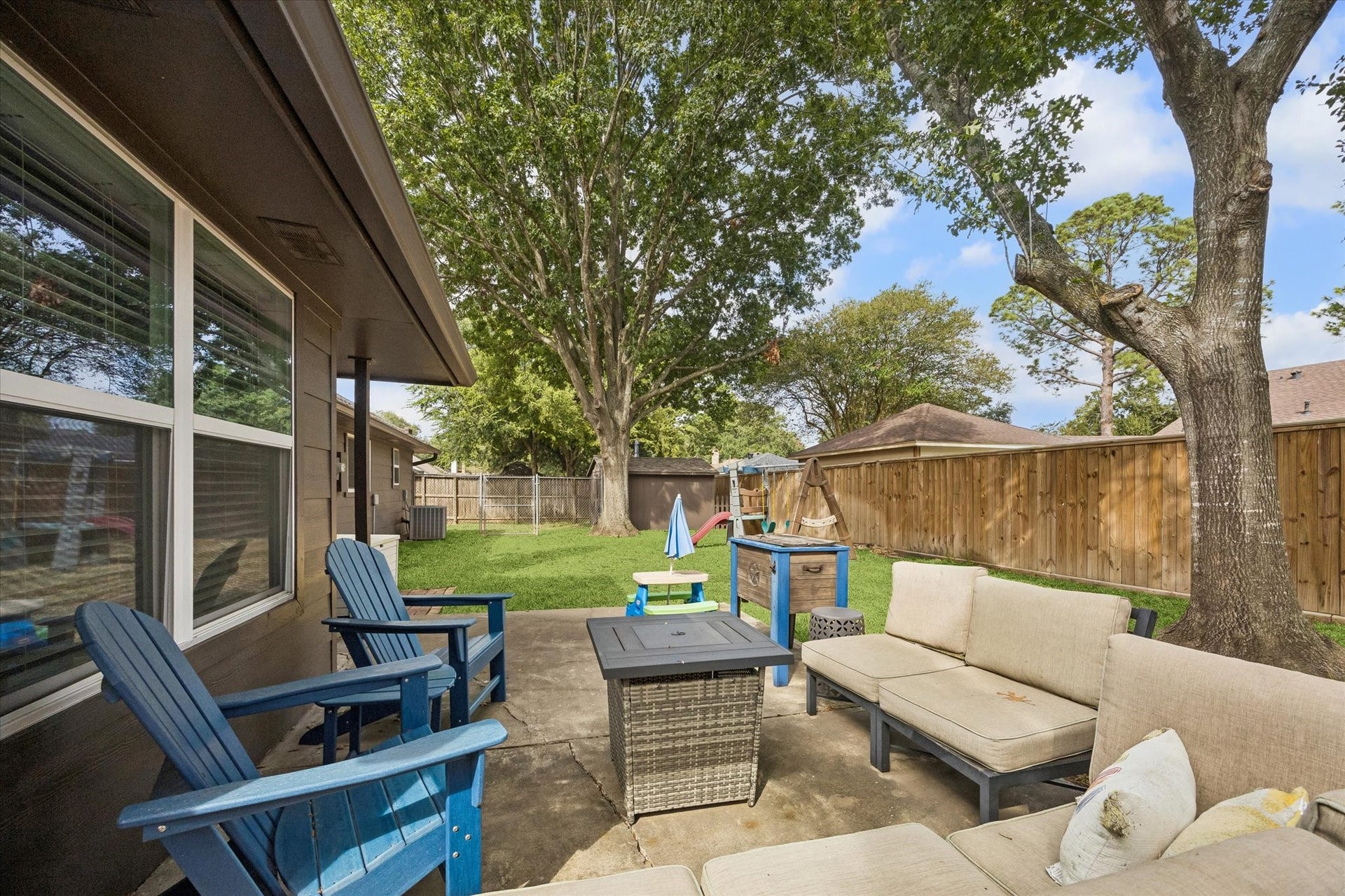 5914 Y Street, Katy, TX 77493 Secluded back porch graced by shade from mature trees is the perfect place to unwind!