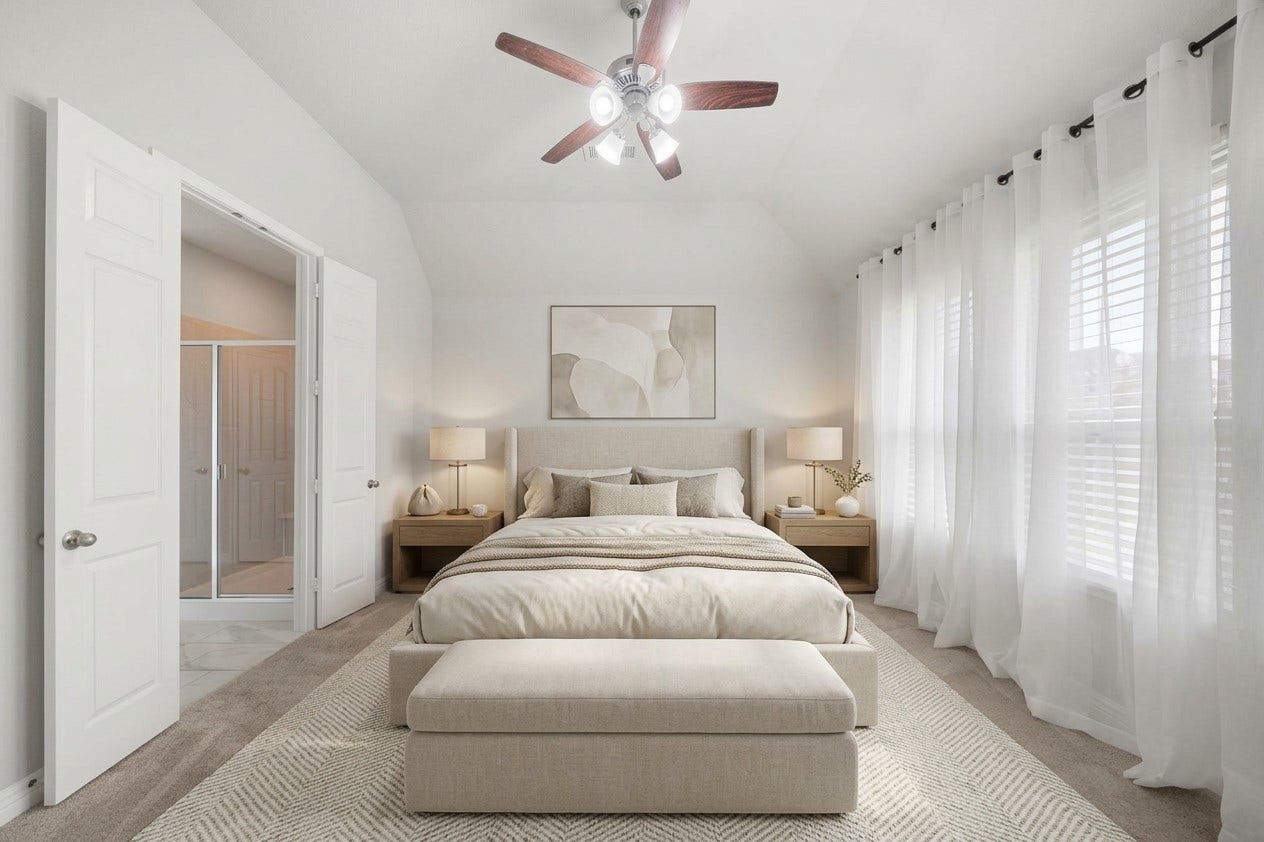 The spacious primary bedroom offers a peaceful retreat with soft carpeting, a high ceiling, ceiling fan, and a wall of windows dressed in sheer curtains. Neutral tones enhance the light and airy feel, while direct access to the adjoining bath adds comfort and convenience to this generously sized private space. This photo has been virtually staged for visual reference.