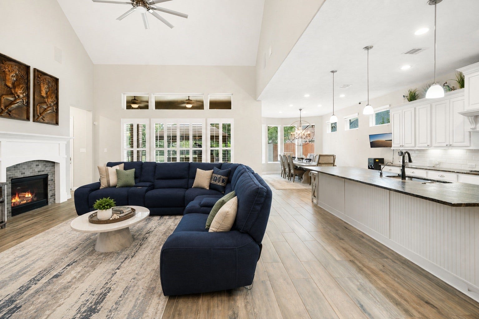 This view showcases the home's open-concept flow, with the living area seamlessly connecting to the kitchen and dining space  ideal for everyday living and entertaining. Virtually staged.