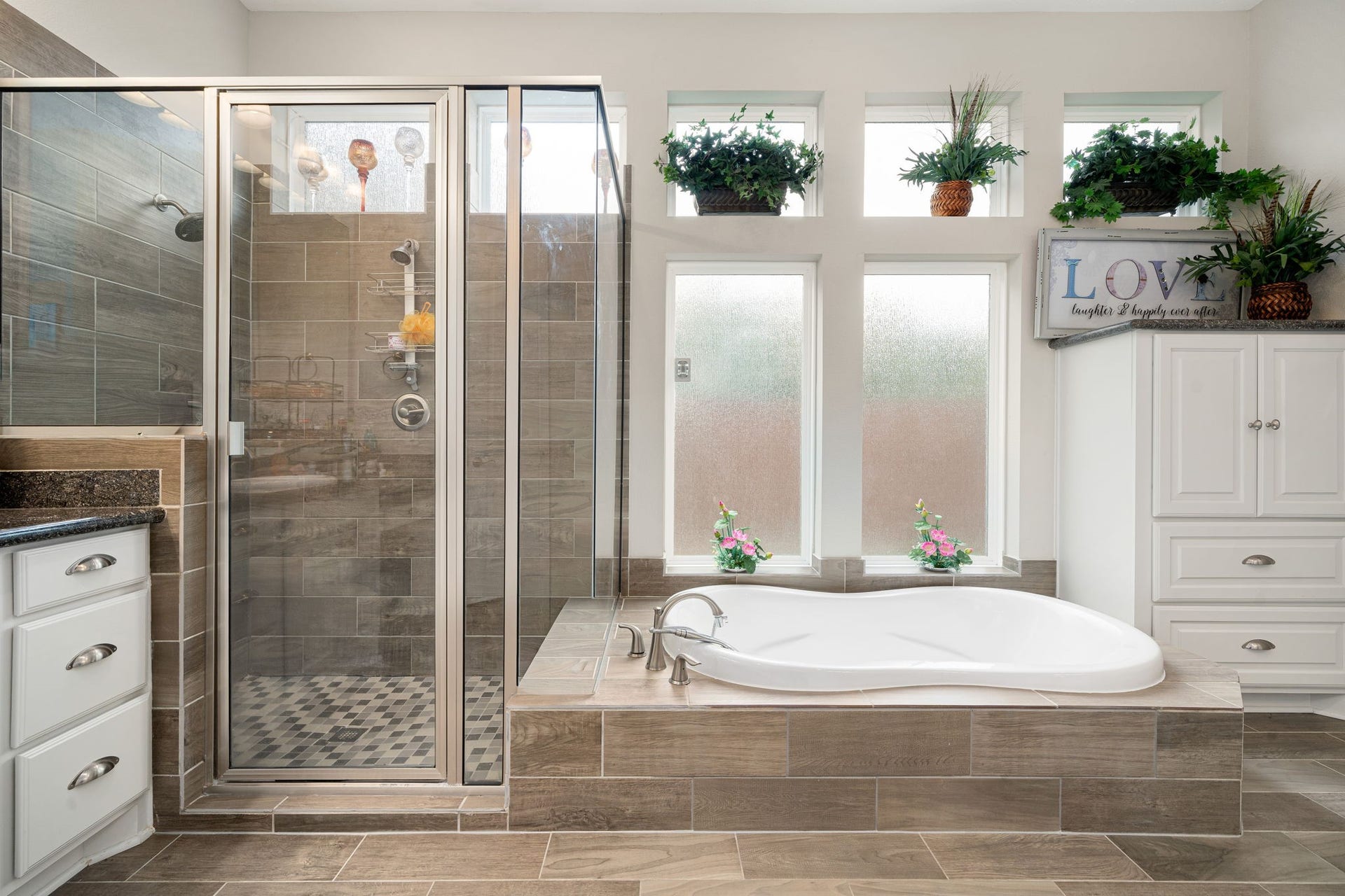 A closer look at the soaking tub and glass-enclosed shower, finished with tile surround and natural light throughout.