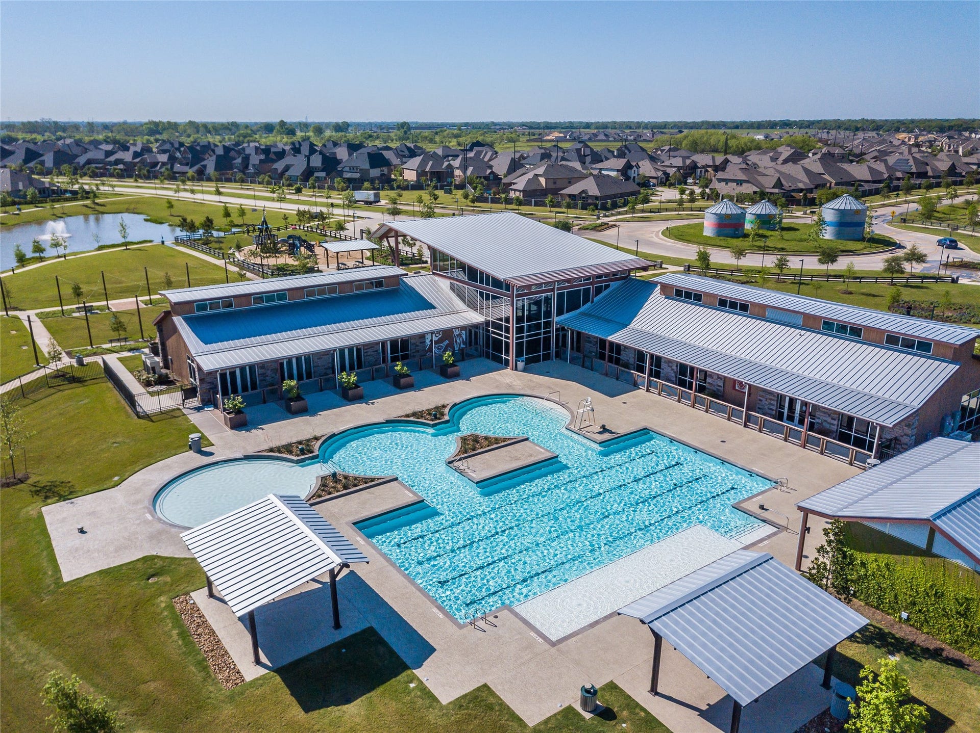 Overlooking one of the communitys central gathering areas, this amenity complex offers open-air spaces designed for recreation, relaxation, and neighborhood events. The combination of waterfront views, landscaped common areas, and family-friendly outdoor features reflects the connected lifestyle Harvest Green is known for.