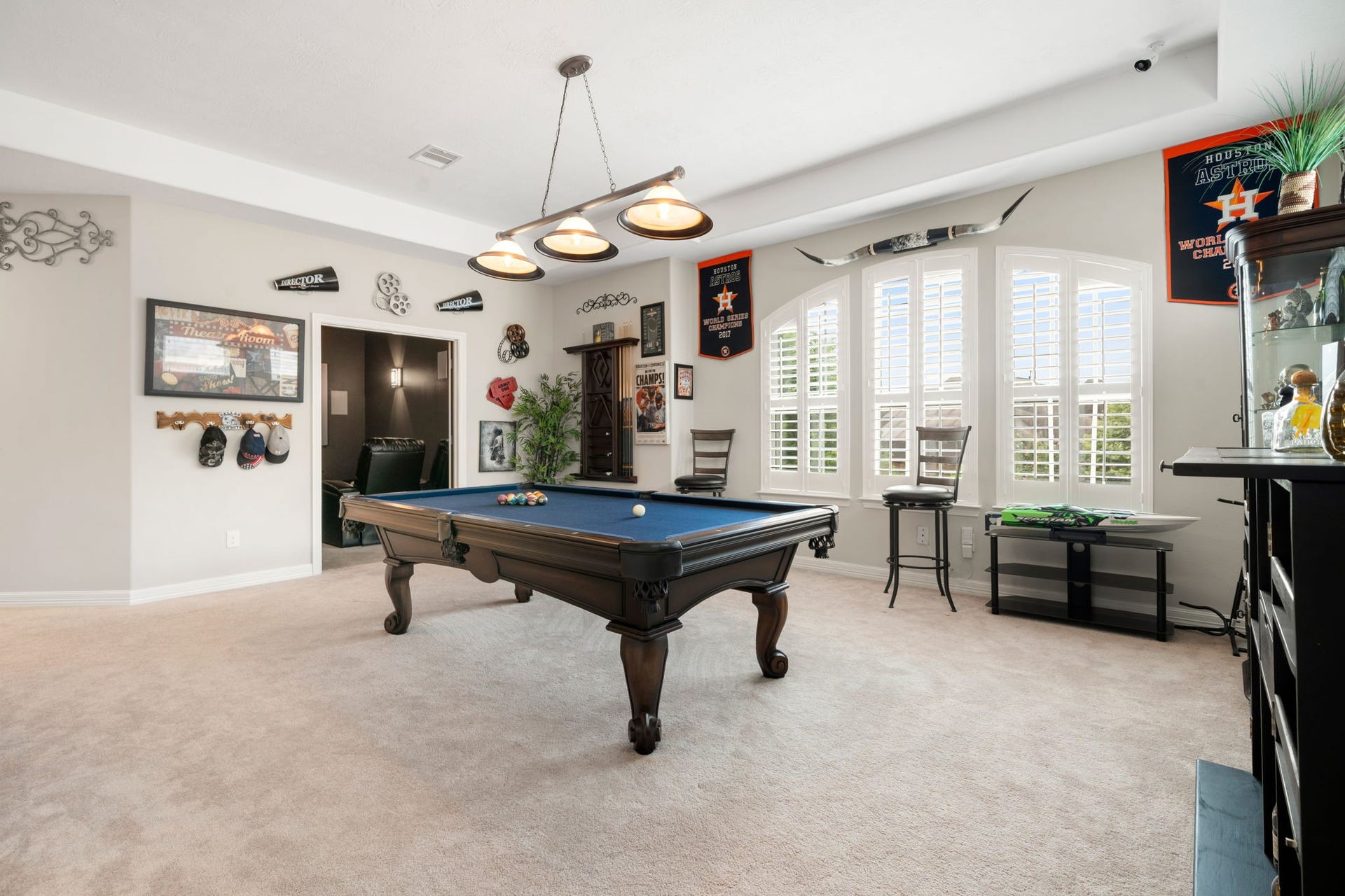 A versatile gathering space upstairs, ideal for game nights or a media lounge, with direct access to the adjoining theater room.