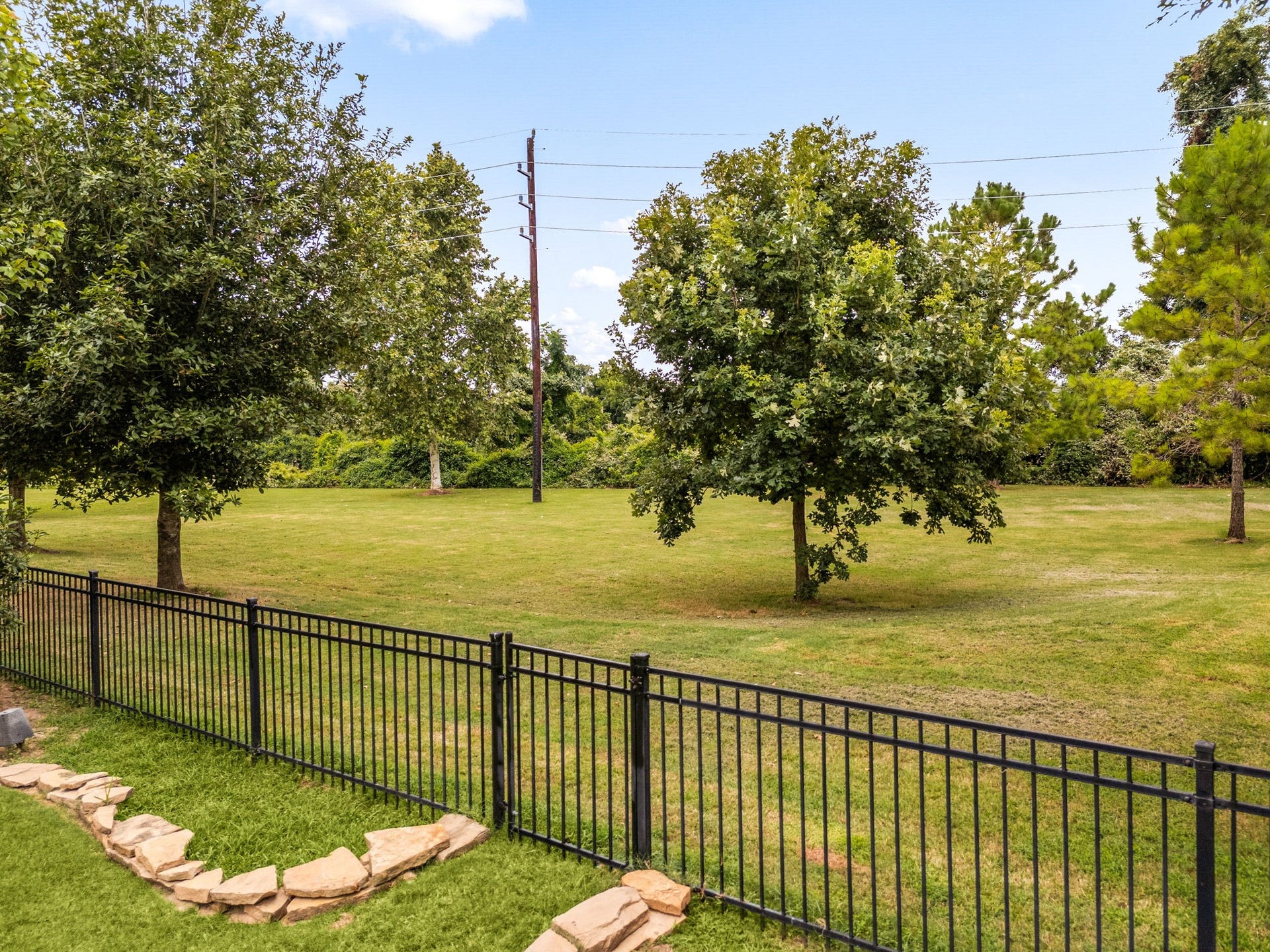 The property backs to green space, offering an open view beyond the fence line for added privacy.
