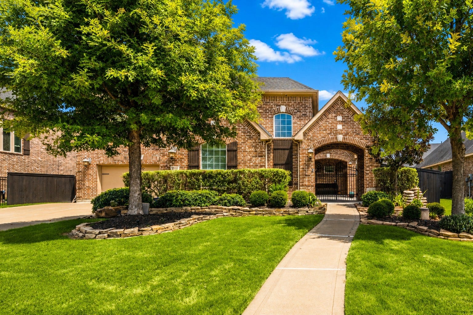Beautifully maintained landscaping and a private gated courtyard add character and charm to this impressive home.