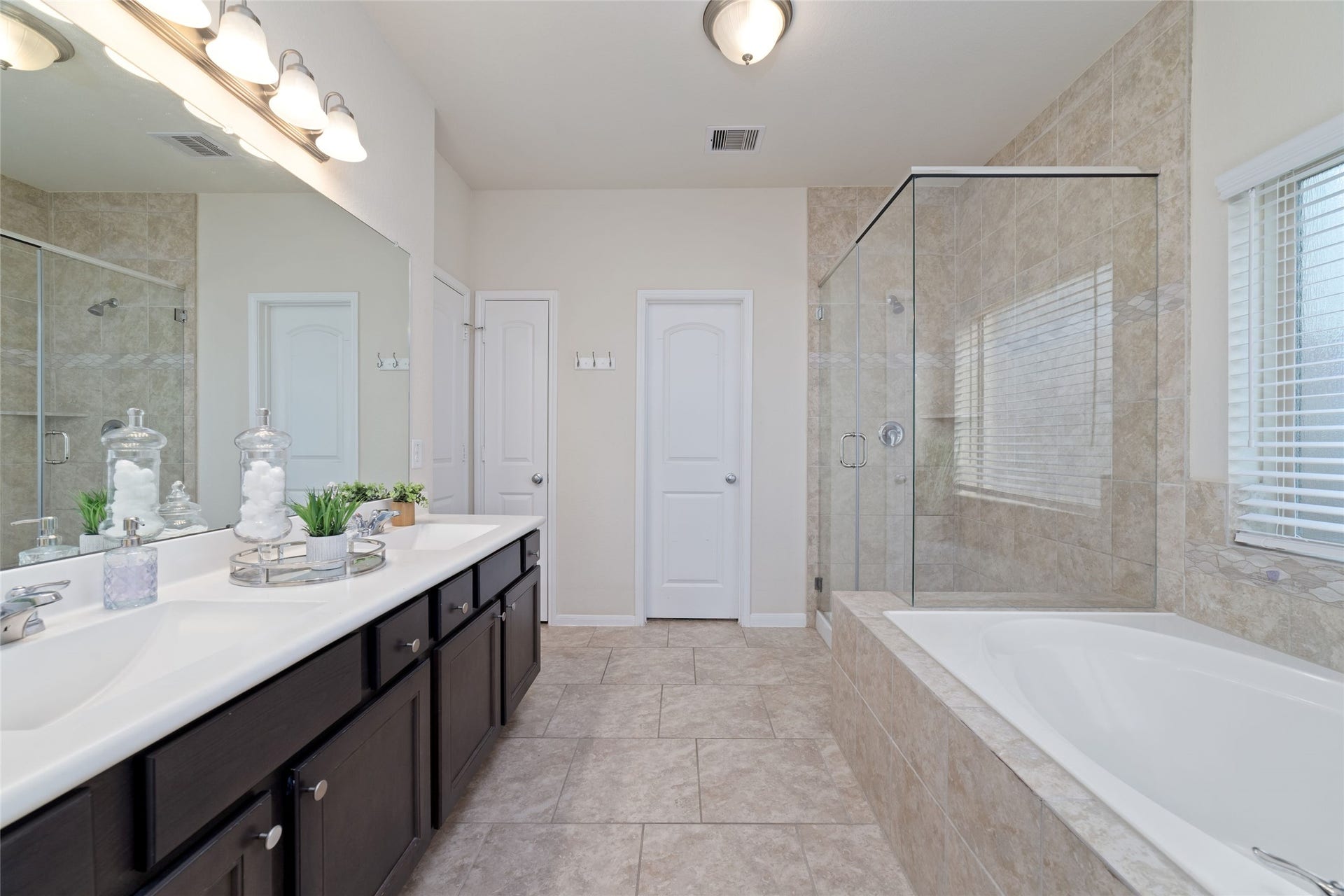 Separate sinks with abundant vanity and storage space.
