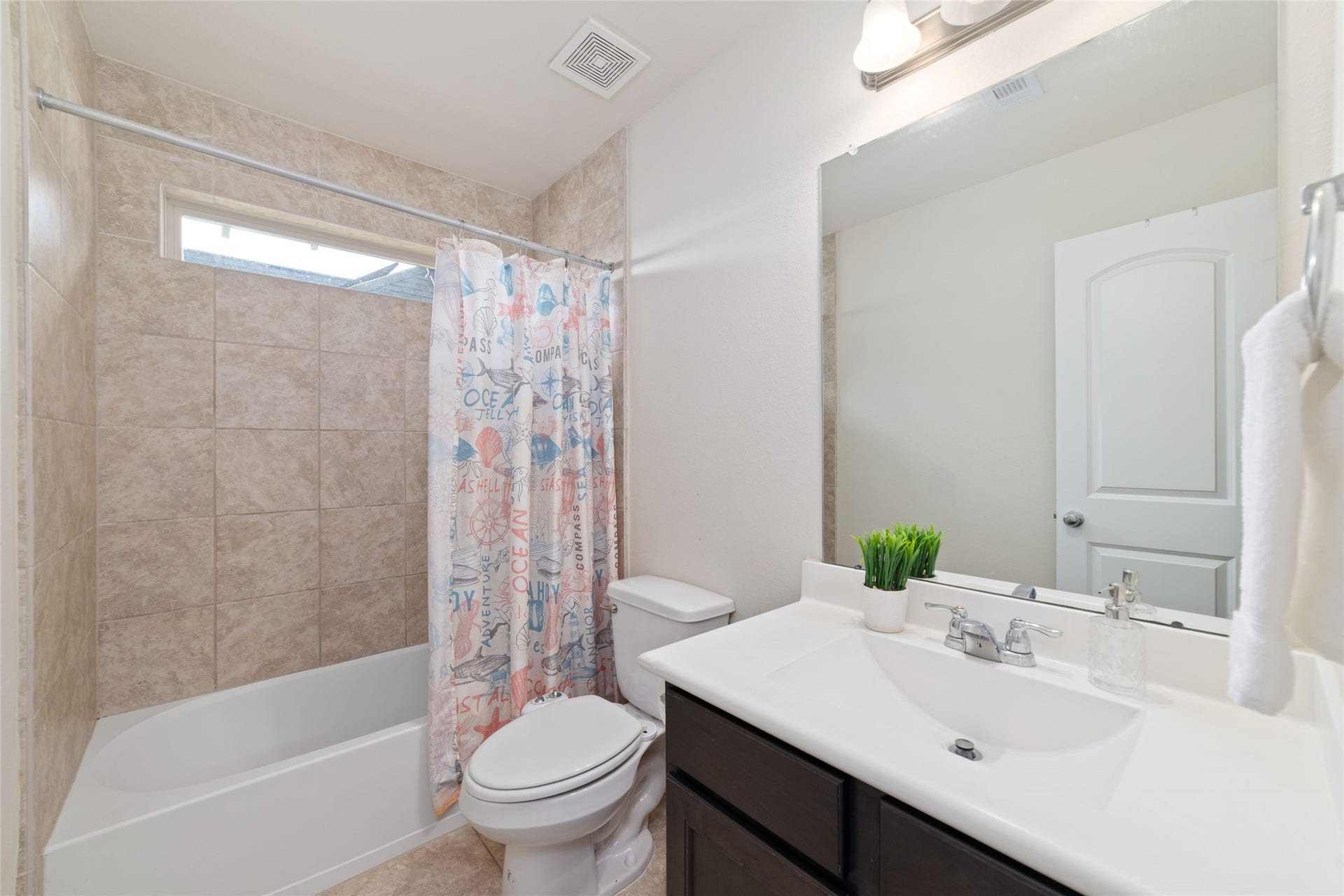 Second upstairs full bathroom, located in the hallway between two of the upstairs bedrooms.