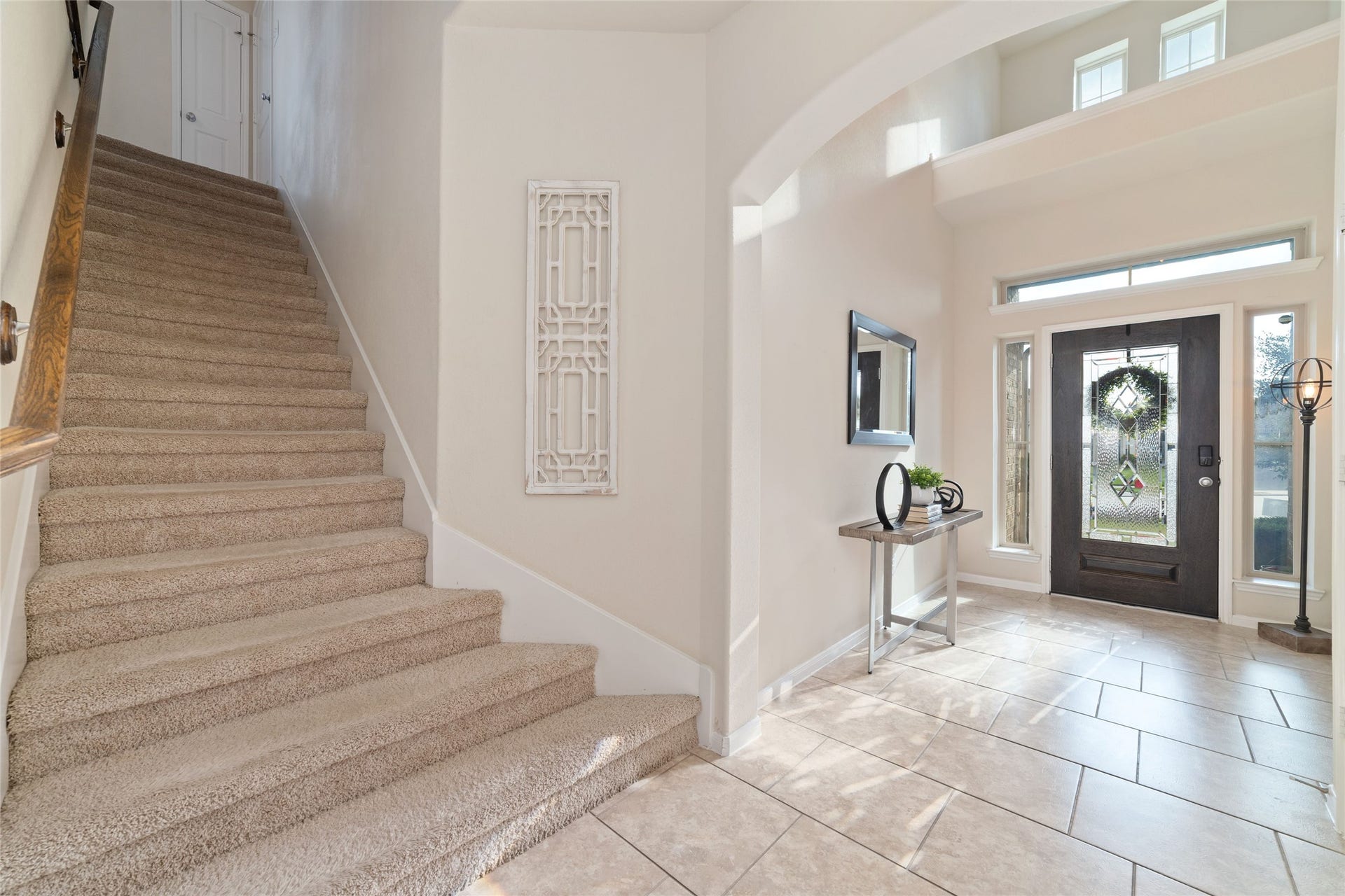 Stairs right off of the entry lead to secondary bed and bathrooms.