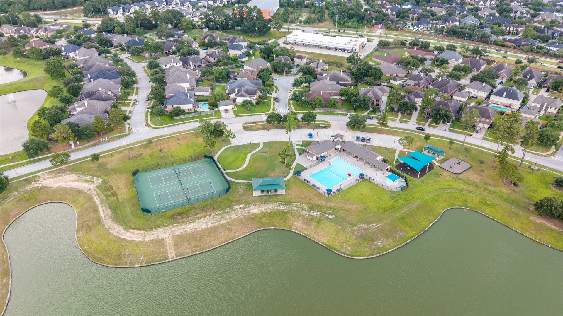 Aerial view highlighting the amenities, lake and walking trails.