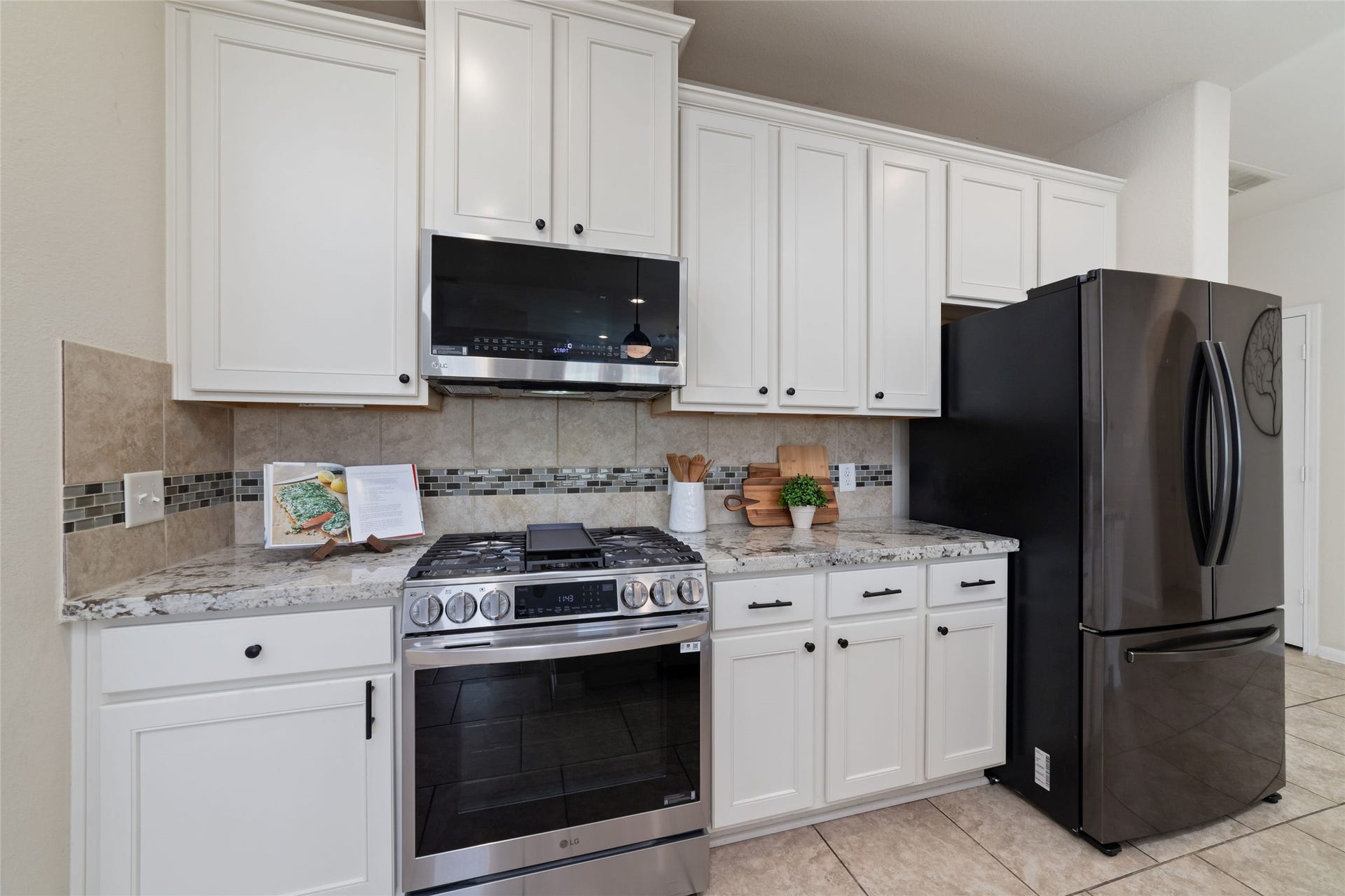 Plenty of cabinet space, stainless steel appliances and a convenient pantry make this kitchen as functional as it is beautiful.