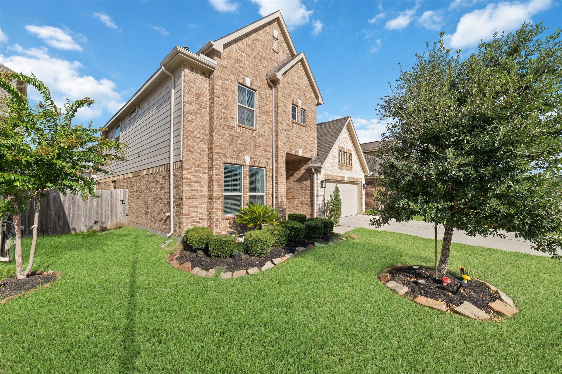 Charming curb appeal with mature trees and landscaping.