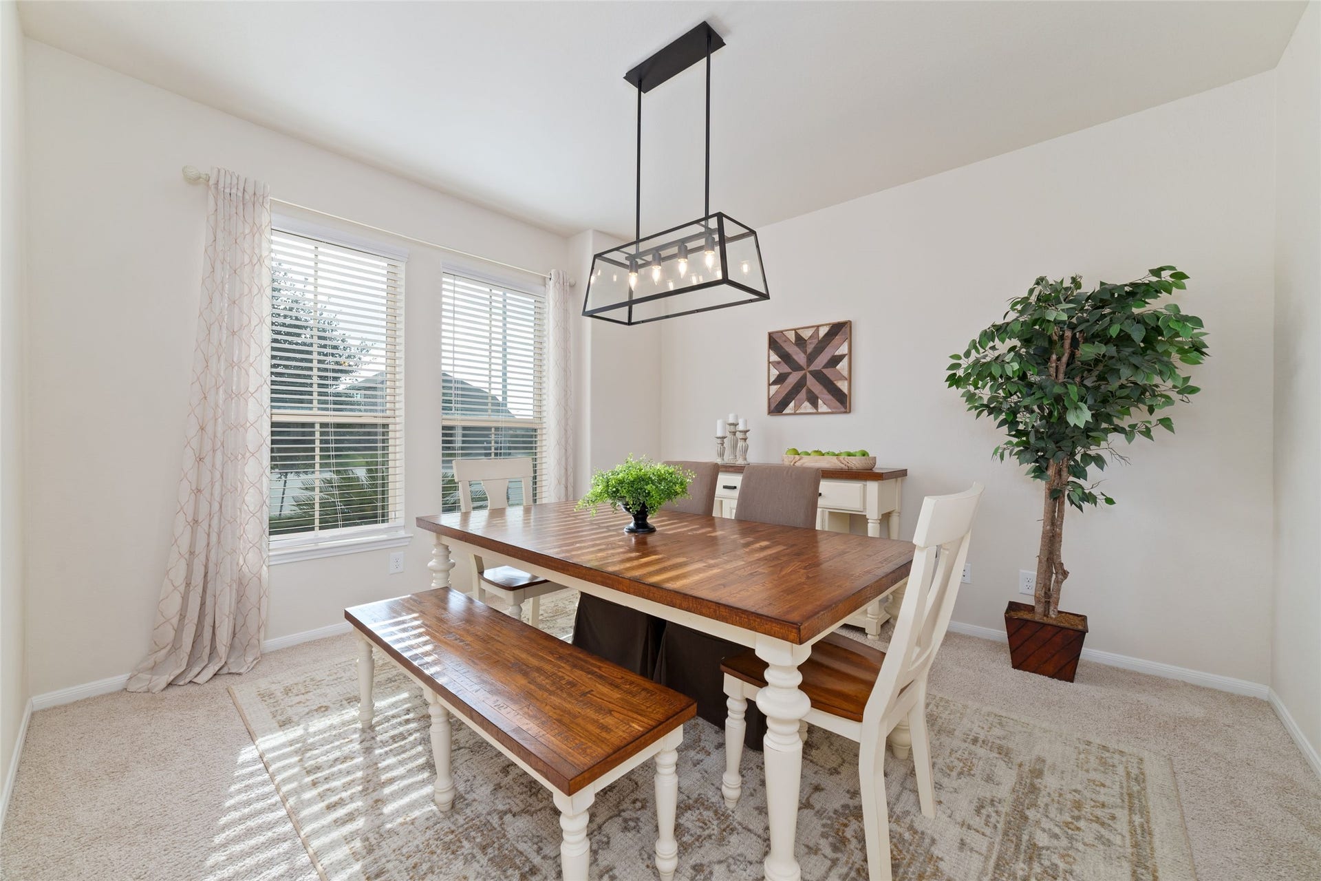 The formal dining room is right off of the entry with updated modern lighting