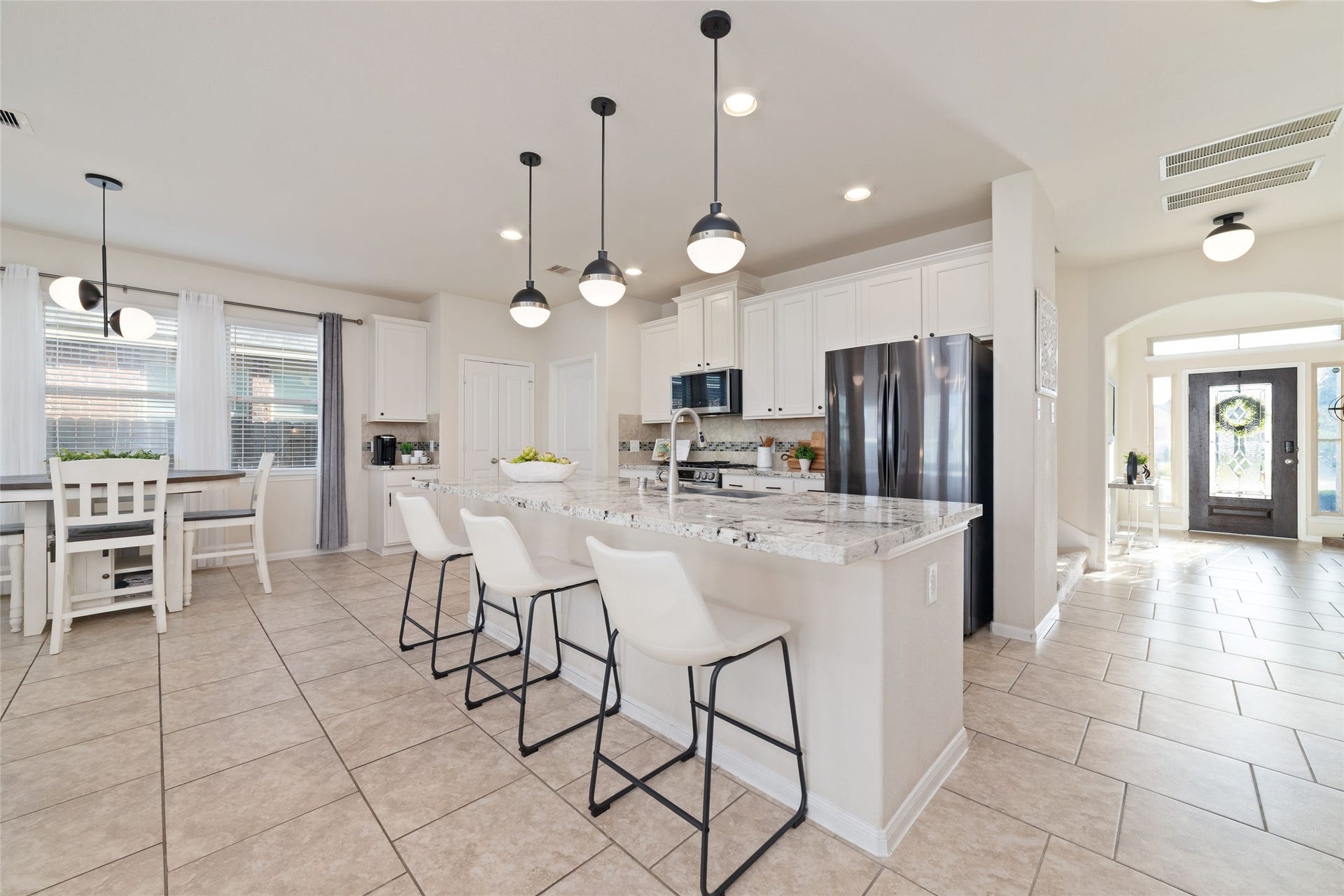 Beautiful and functional kitchen with a large island, plenty of countertop workspace and additional seating.